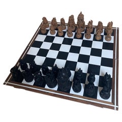 At Auction: A large ornate chess set with sterling silver board. Board  measures 46x46x8cm