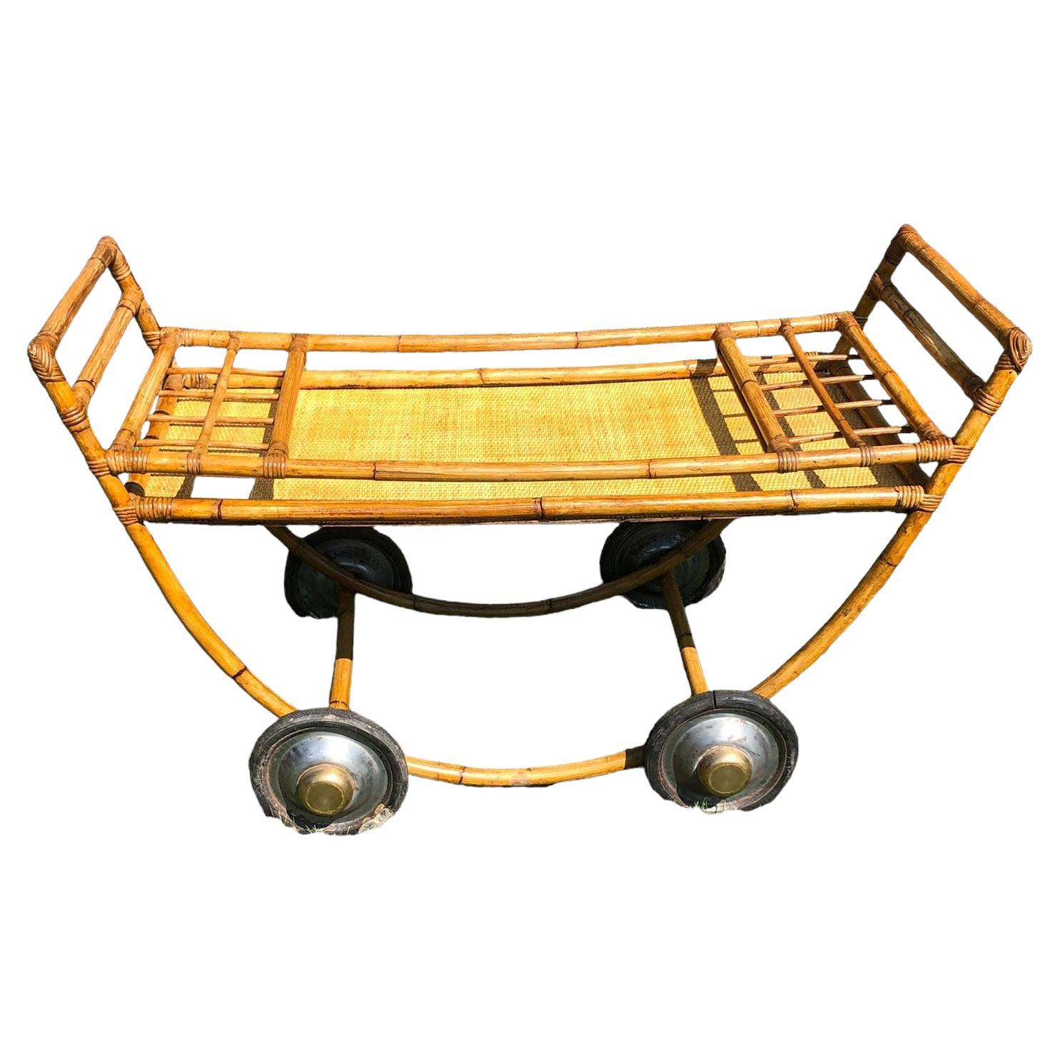 Large Vintage Rattan Bar Cart with Bottle Holders surface. The top of the serving surface is 18. Cart is in good vintage condition with cracks in the rubber wheels and some rust present. Cart has a fresh coat of shellac for years of drinking