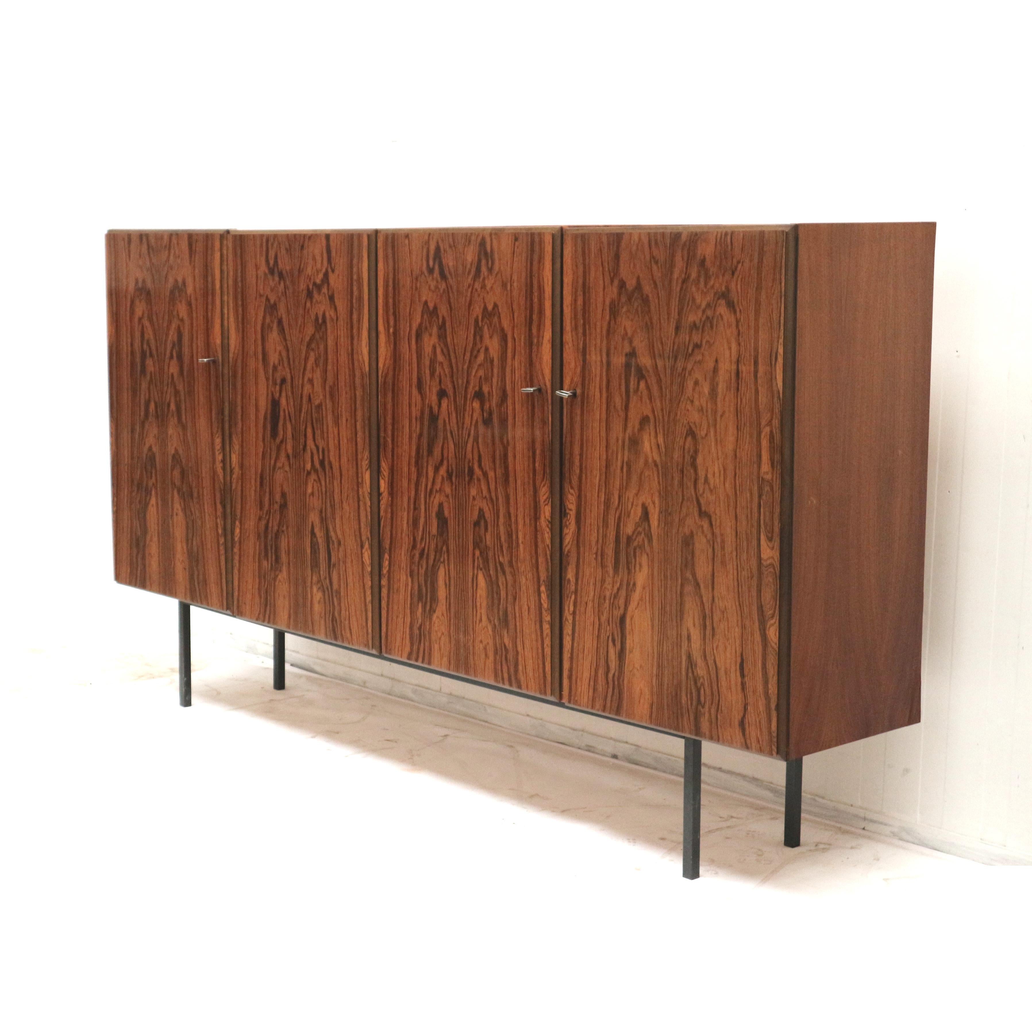 Large vintage rosewood sideboard / highboard made in the 60.

Dimensions:
Width: 240 cm
Height: 132 cm
Depth: 44 cm

The sideboard has traces of use matching the age of the cabinet.
