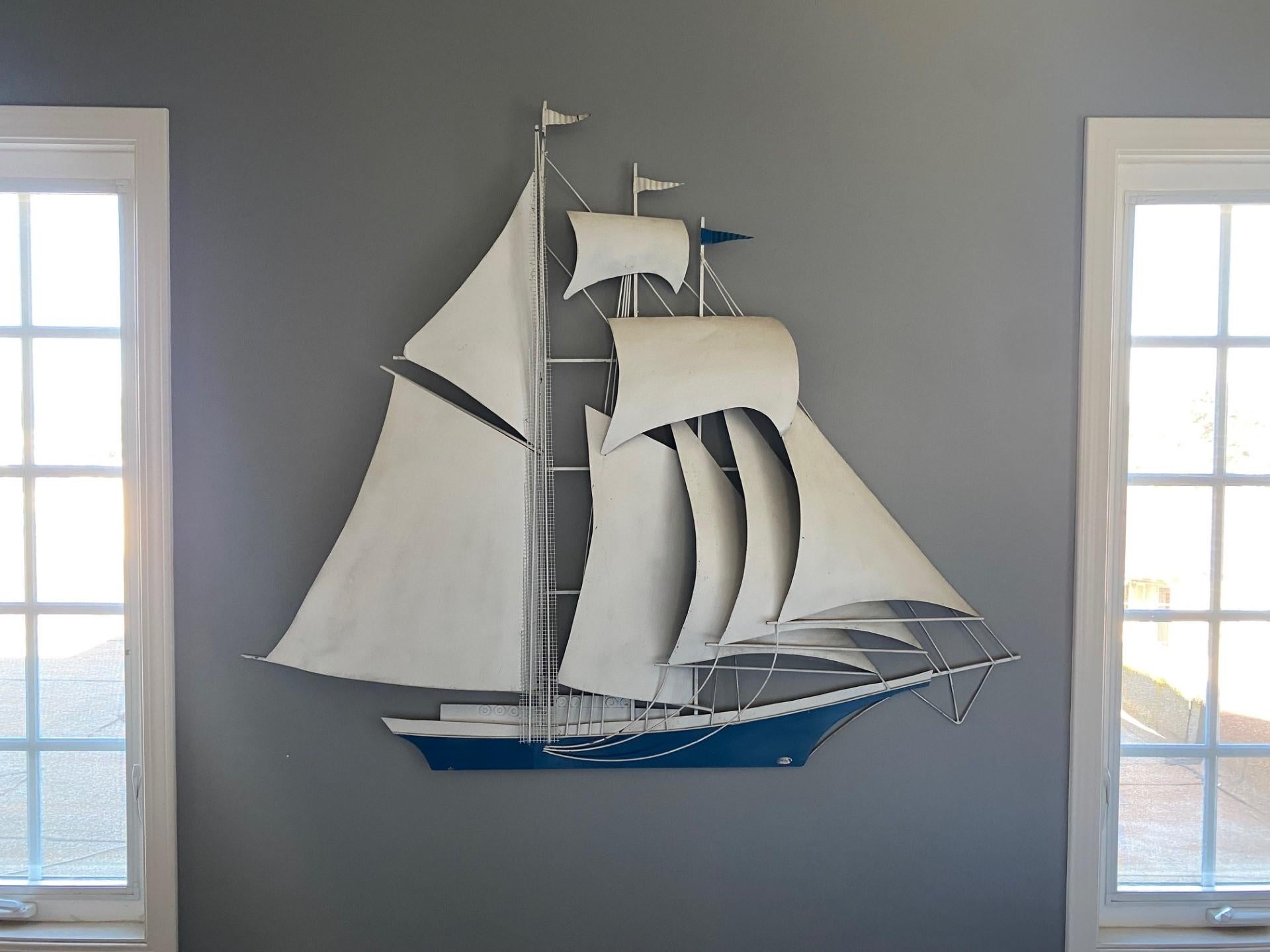 Mid-Century metal wall sculpture signed by artist Wiley. Beautiful design that floats majestically with easy and simplicity. The sculpture is light to the eye while complex in design and construction. The nautical theme is highlighted with shades of