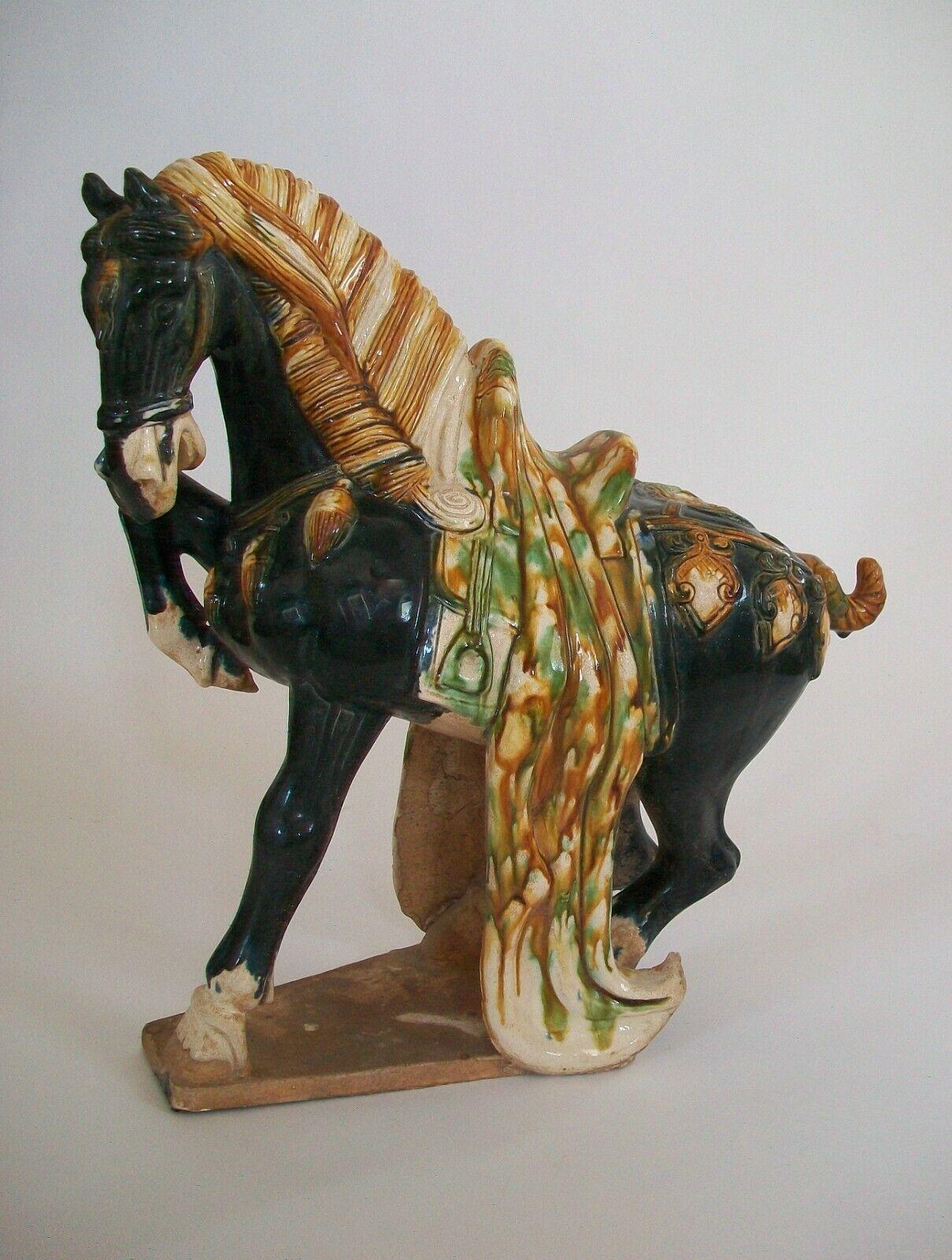 Large vintage sancai glazed Tang style ceramic horse - molded form - hand painted black glaze to the horse and ' egg and spinach ' glaze to the saddle and decorative elements - unsigned - China - mid / late 20th century.

Excellent vintage