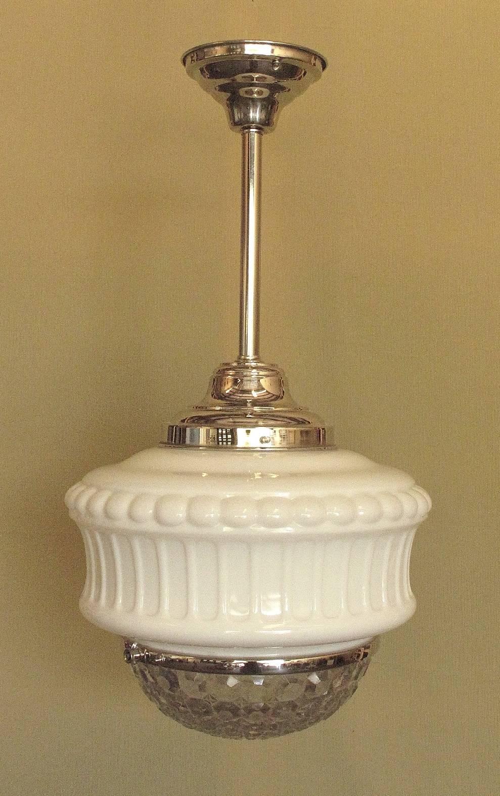 Three available but there may be more coming in.
These are 1920s vintage bank lobby, drugstore, department store, or schoolhouse electric lighting fixtures. They are two pieces of glass held together by a metal band which can expand to allow the