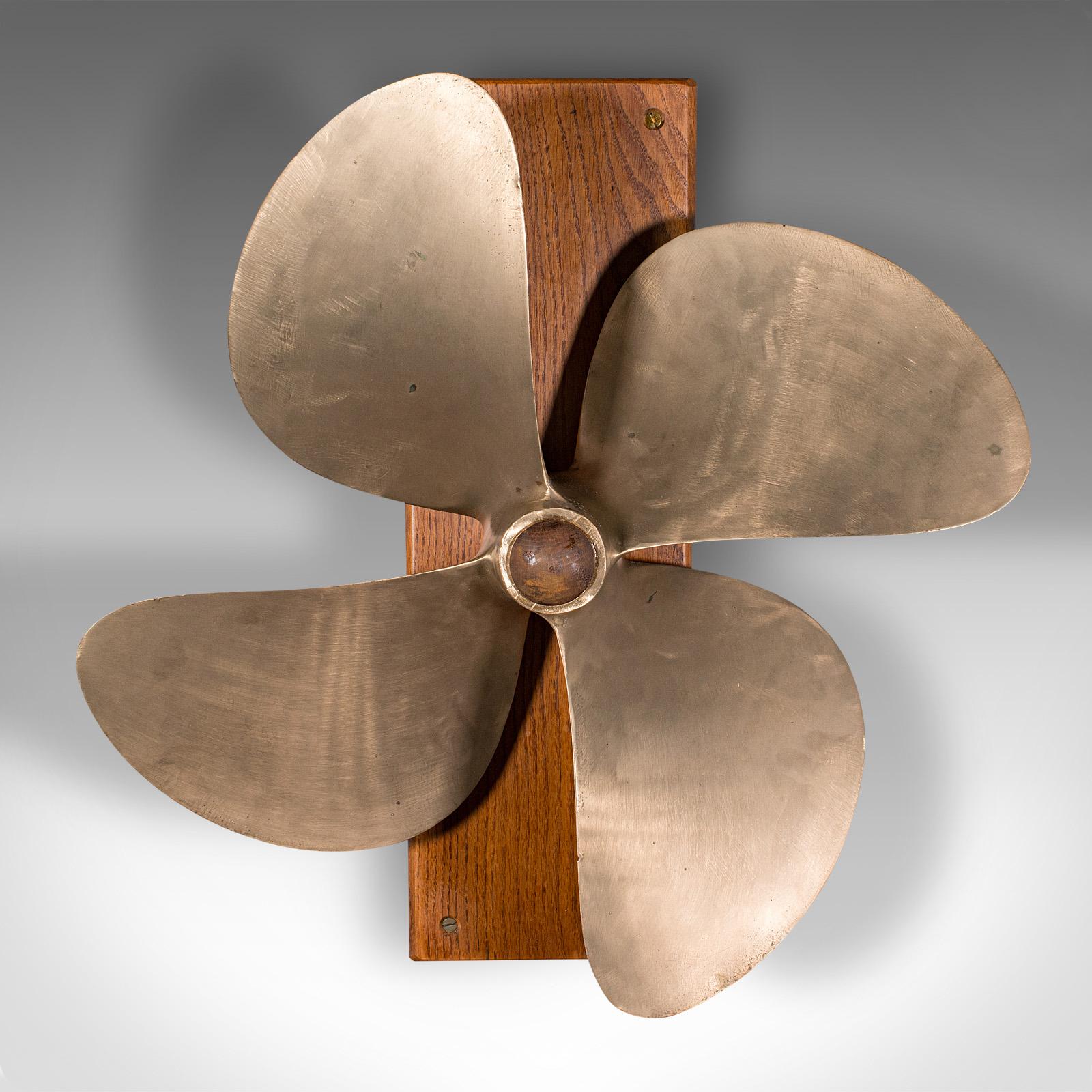 This is a large vintage ship propeller display. An English, bronze and oak decorative four-blade maritime mount, dating to the mid 20th century, circa 1950.

Of great proportion and superb decorative appeal
Displaying a desirable aged patina and in