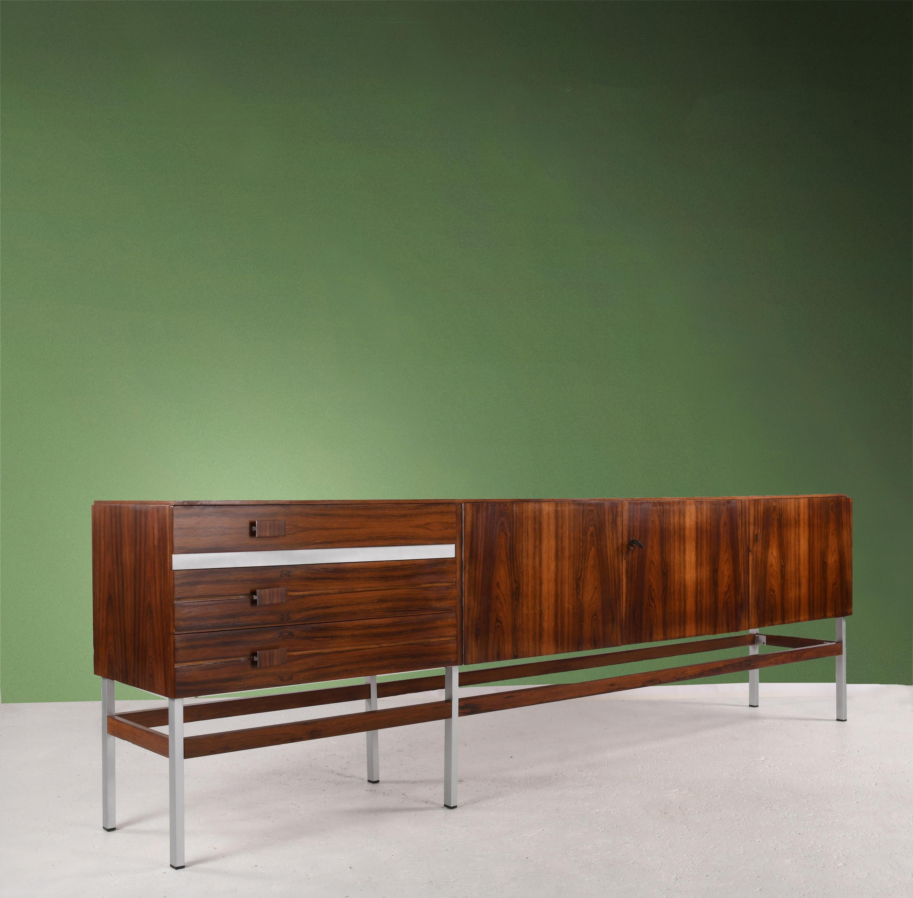 Large enfilade (W: 240 x D: 45cm H: 78cm) made in Germany in the 1960s, opening 3 doors and 3 drawers. Walnut veneer on the outside and lemon veneer on the inside. Beautifully detailed aluminium drawer handles, also veneered on the front, and drawer