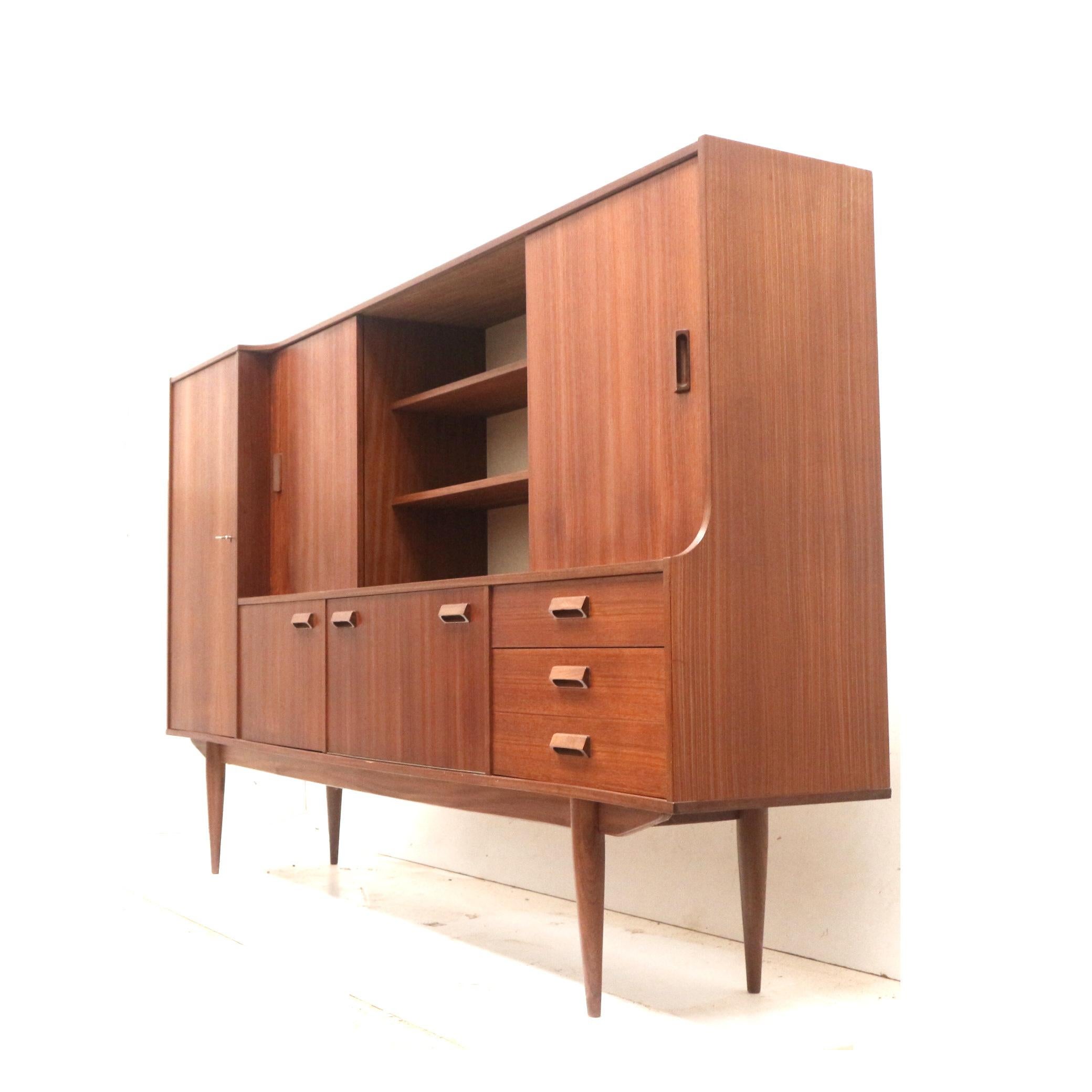Large vintage sideboard / highboard / wall unit made in the 60s.

Dimensions:
Width: 225.2 cm
Height: 135.8 cm
Depth: 43 cm

The cabinet has traces of use appropriate to its age.