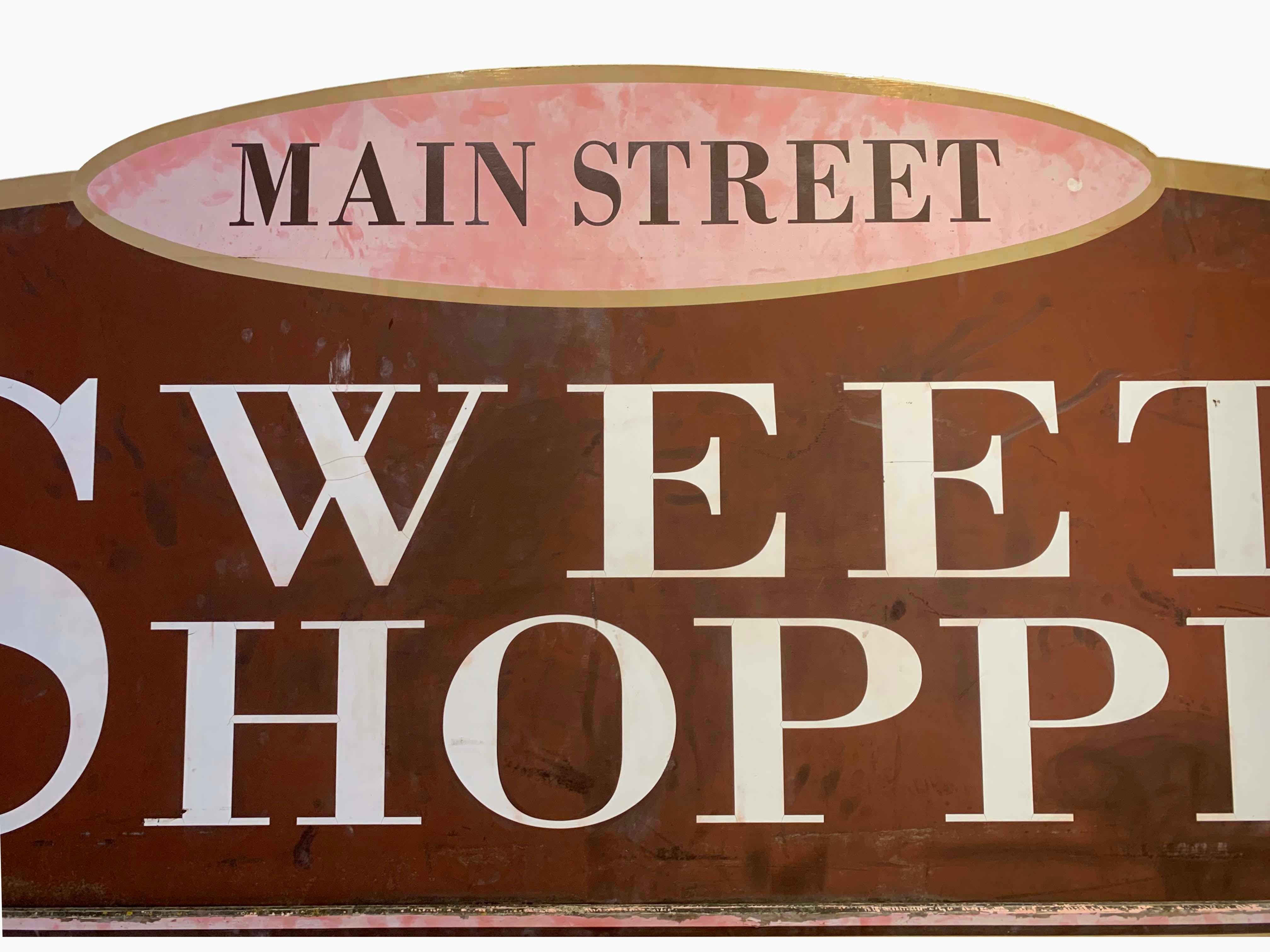 Large one of a kind wooden sign with fantastic details. Great colors and intricate shapes. Originally hung outside a CT sweet shop.