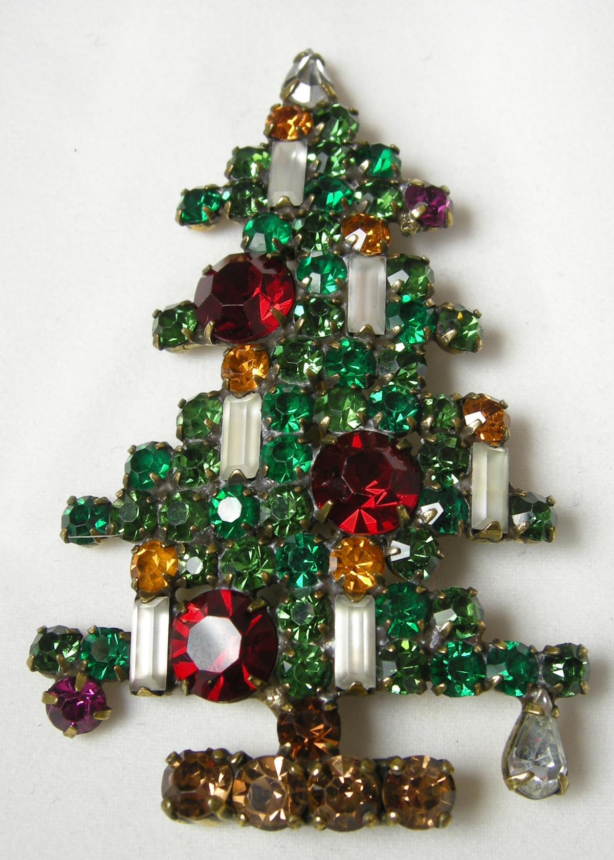 This large vintage signed Weiss Christmas tree brooch five candles amidst multi-color crystals in a gold tone setting. In excellent condition, this brooch measures 2-7/8” x 1-3/4” and is signed “Weiss”.