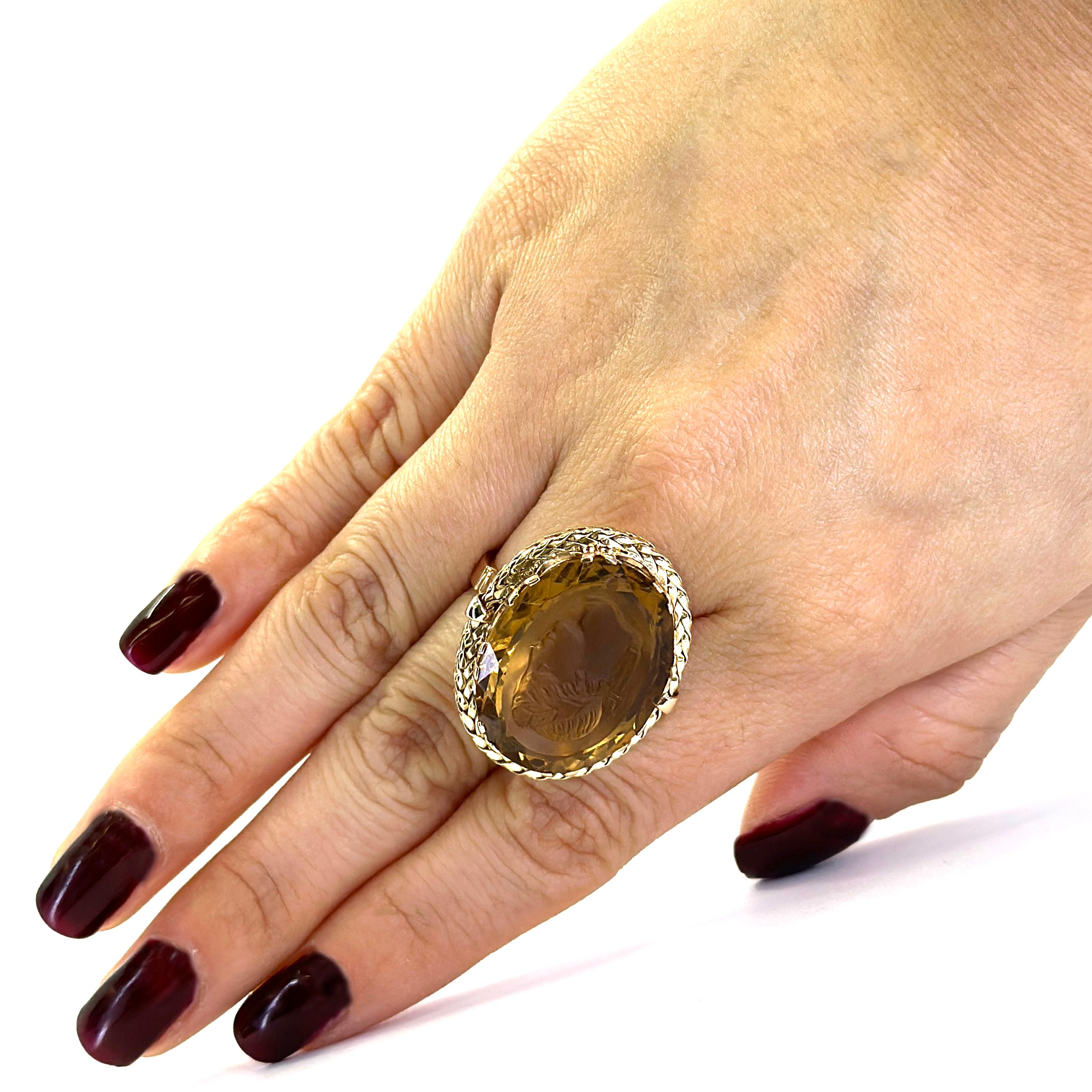 Large 14 Karat Yellow and Rose Gold Intaglio Ring Featuring a 24mm x 19mm Oval Citrine Weighing Approximately 24 Carats. Profile of a Greek Man Carved into the Stone. Textured Yellow Gold Rope Edge with Rose Gold Band. Finger Size 8. Includes One