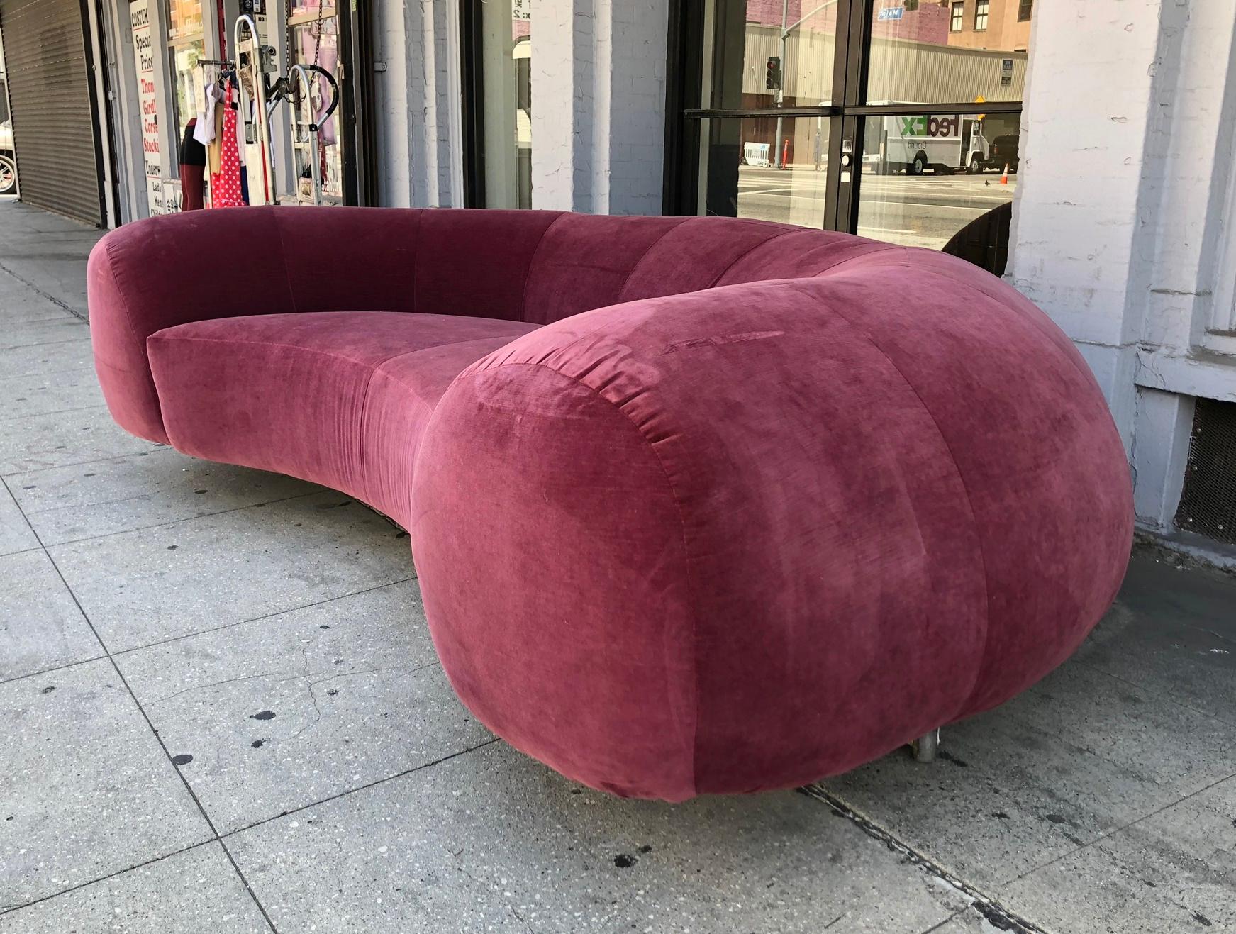 Beautiful vintage sofa newly upholstered in a burgundy fabric, the sofa sits low to the ground, it has an exaggerated round back and a seating area that can accommodate 2-3 people comfortably.
The sofa is newly upholstered and is in very good