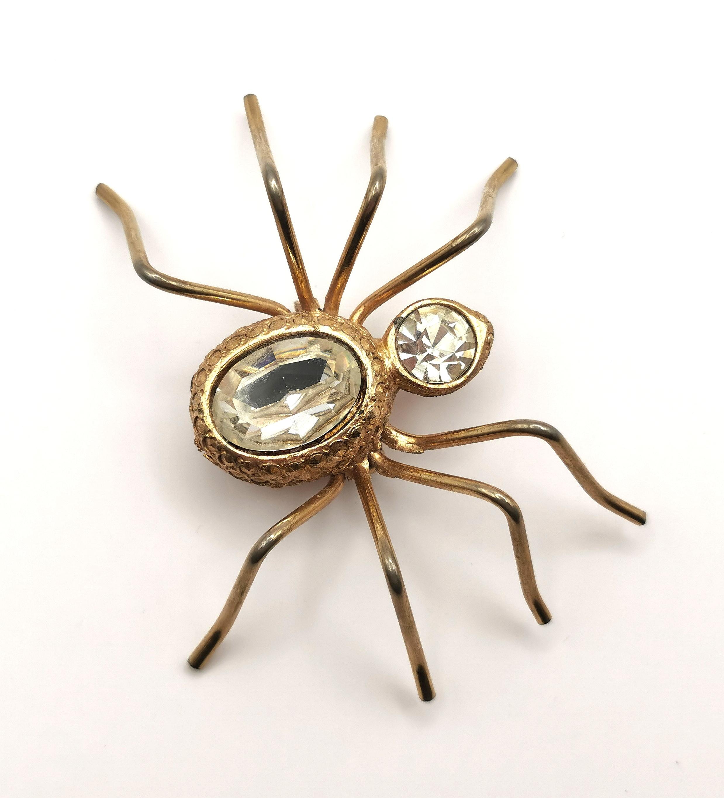 An attractive large vintage spider brooch.

Crafted in a rich gold tone metal, it is a good sized piece, well designed and it is set with two clear paste stones to the body and head.

The metal is slightly textured and this brooch is really set to