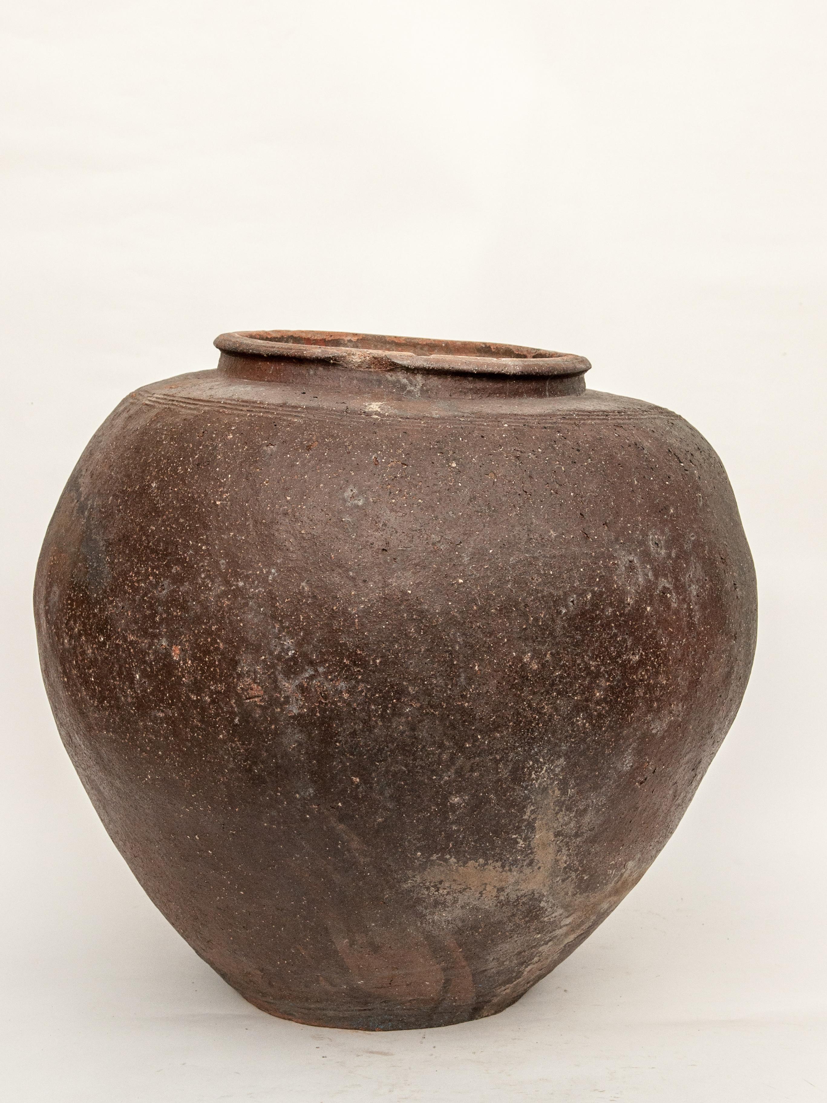 Large vintage storage or water jar from Borneo. Unglazed, mid-20th century. Offered by Bruce Hughes.

Dimensions: 23.5 inch diameter by 22 inches tall.