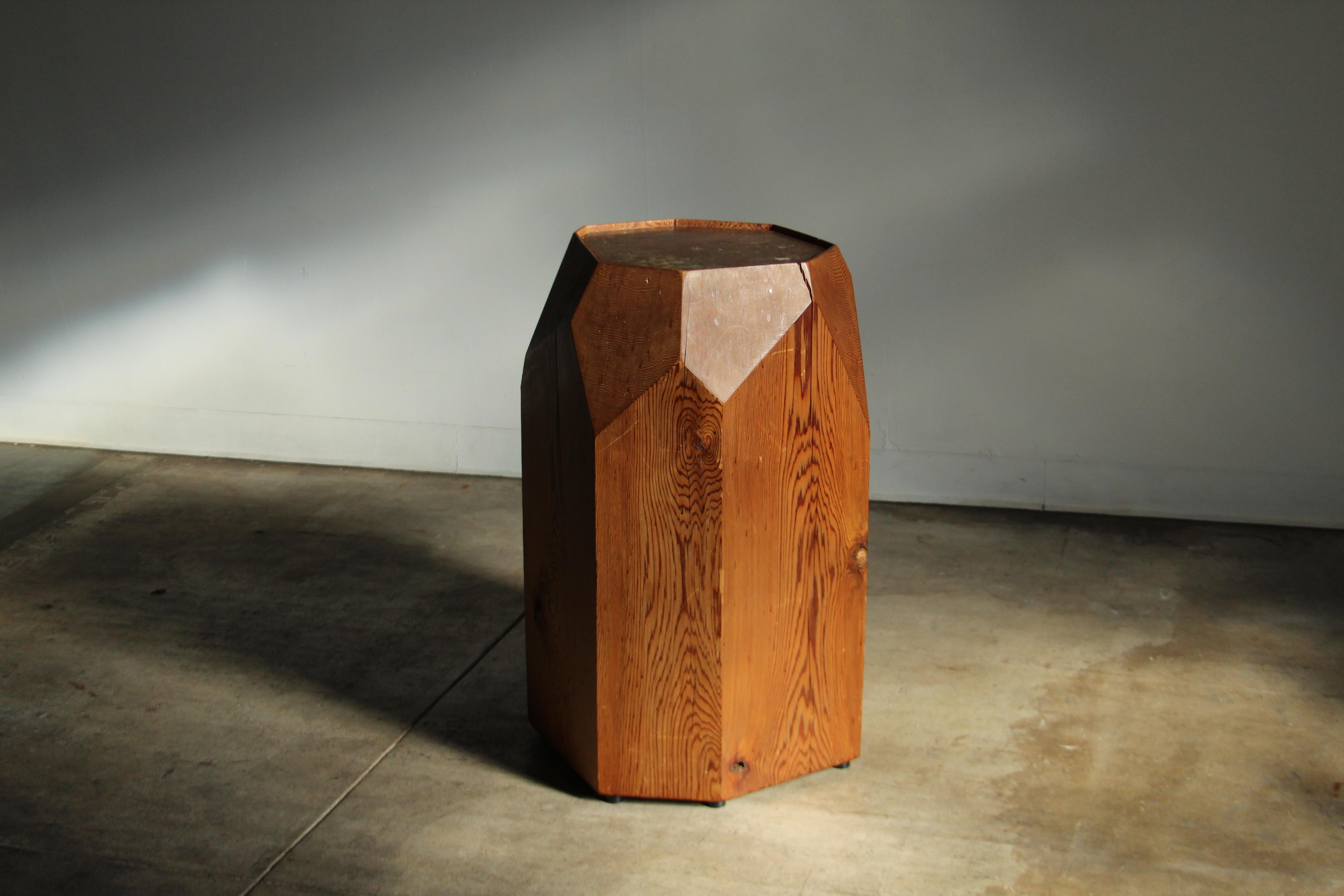 A large and incredible stump form pedestal in the manner of JB Blunk. Organic, minimalist form with thoughtful angular cuts, which turn this piece into a sculpture of its own. The reddish hue of the California pine radiates warmth, and the smooth