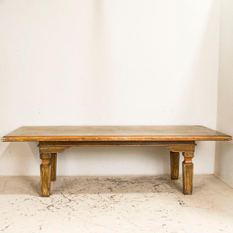 This fabulous, large dining table will make a grand statement due to its impressive size. The wonderfully executed green painted finish is complimented by the elaborate baskets of flowers and flourishes that adorn the top. Please examine the close