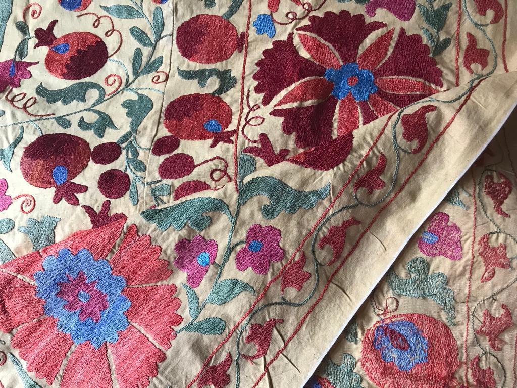 Wonderful colors and design on this large vintage Suzani blanket with all the care and retail of hand embroidered craftsmanship with silk thread on cotton.