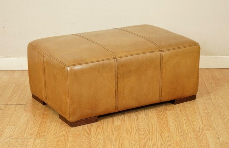 We are so excited to present to you this large footstool/ottoman in vintage tan leather made by Halo.

Because of its size it can easily be shared between 2 people.

We have lightly restored this by giving it a hand clean all over, hand waxed