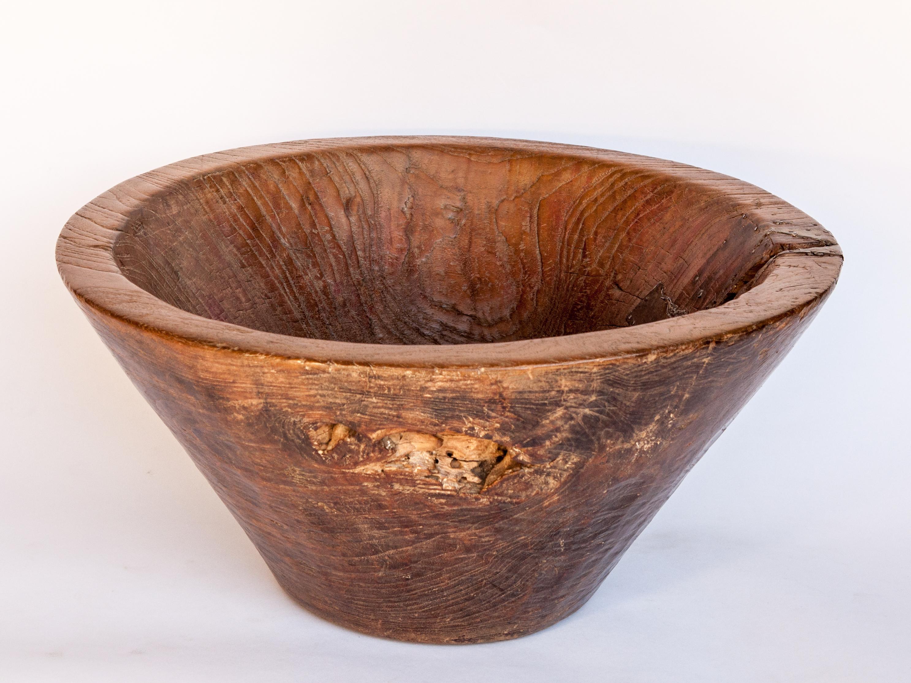 Large vintage teak bowl, hand hewn, 20.75 inch diameter. From Cirebon, North Java, mid-20th century.
This rustic wood bowl was fashioned by hand from a single piece of teak wood and comes from the Cirebon area of Northern Java. It would have been