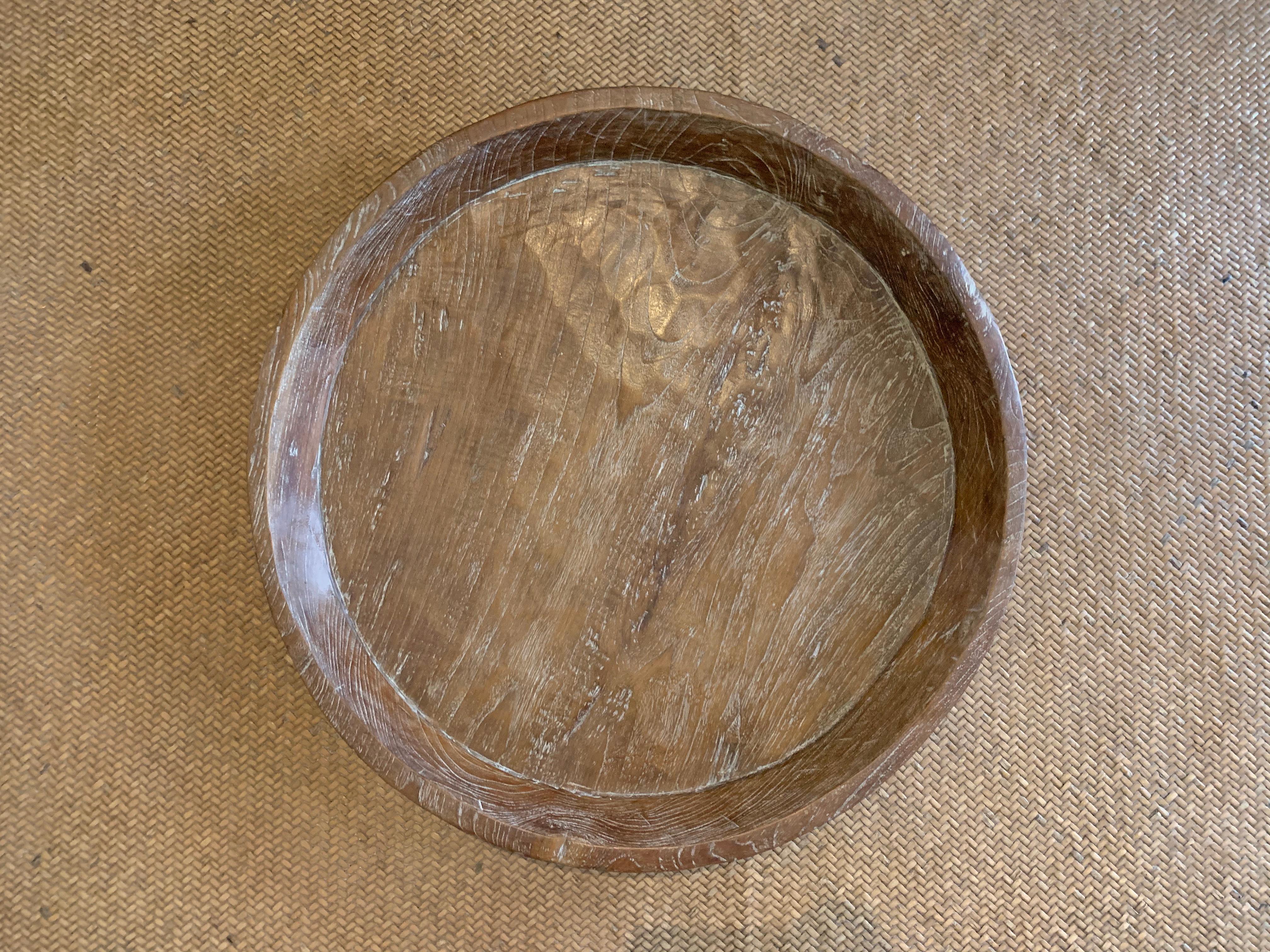 A teak wood bowl crafted on the island of Java, Indonesia with a shiny polished finish. The bowl was cut from a much larger slab of wood and maintains a minimalist design. 

Dimensions: Height 9cm x Diameter 64cm.