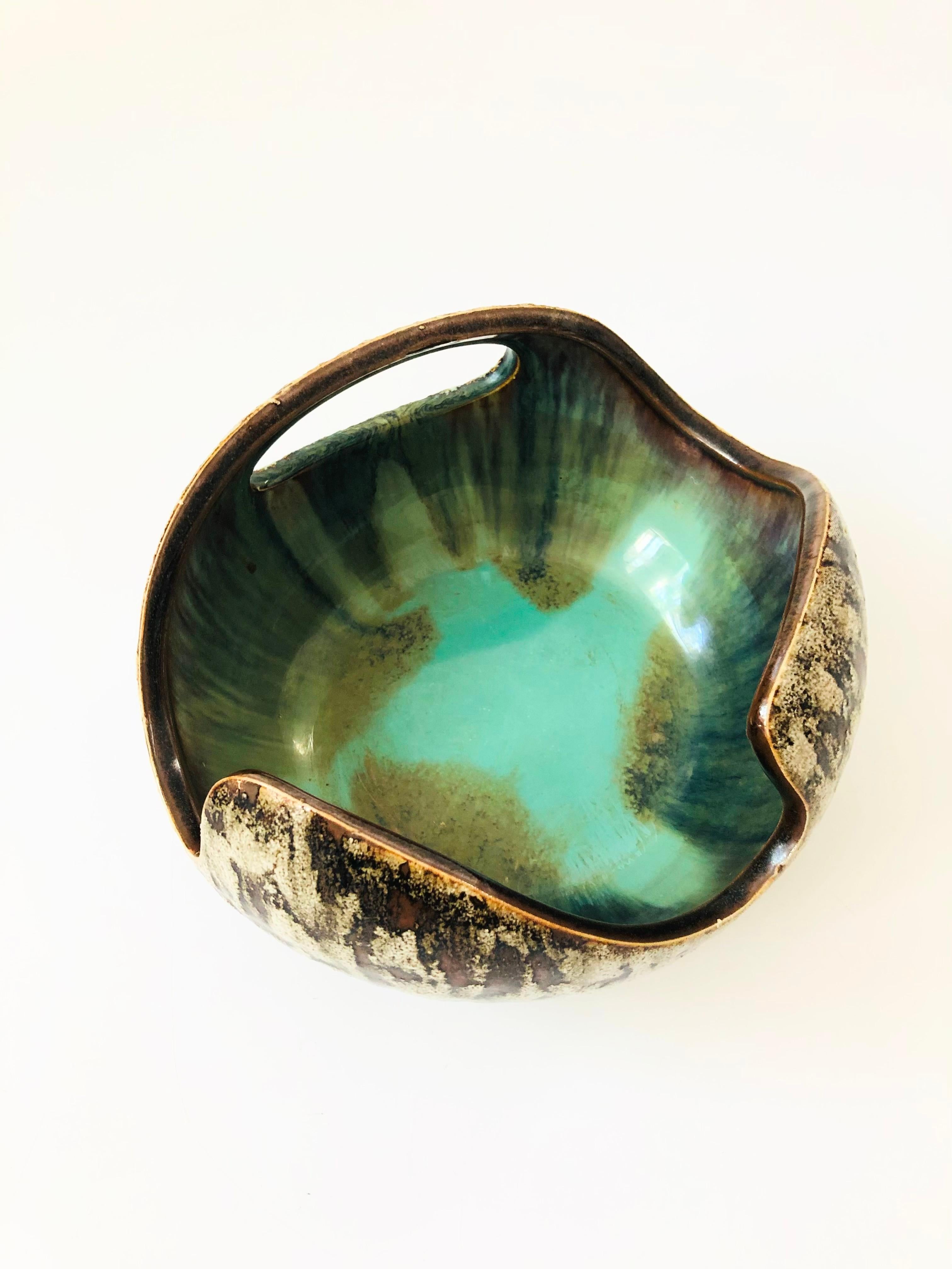 A vintage ikebana pottery bowl. Beautiful organic shape with a textured exterior glaze in natural colors. Contrasting turquoise glaze to the interior. Perfect for creating a sculptural flower arrangement or using as a centerpiece.

