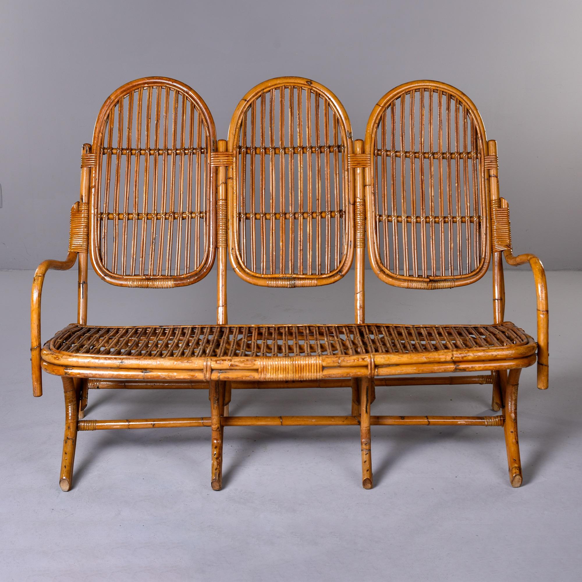 Found in Italy, this three seat rattan settee dates from approximately 1940. Very good vintage condition. Unknown maker

Measures: arm height: 27” seat height: 19.5”
Seat depth: 19.5” seat width: 54.
