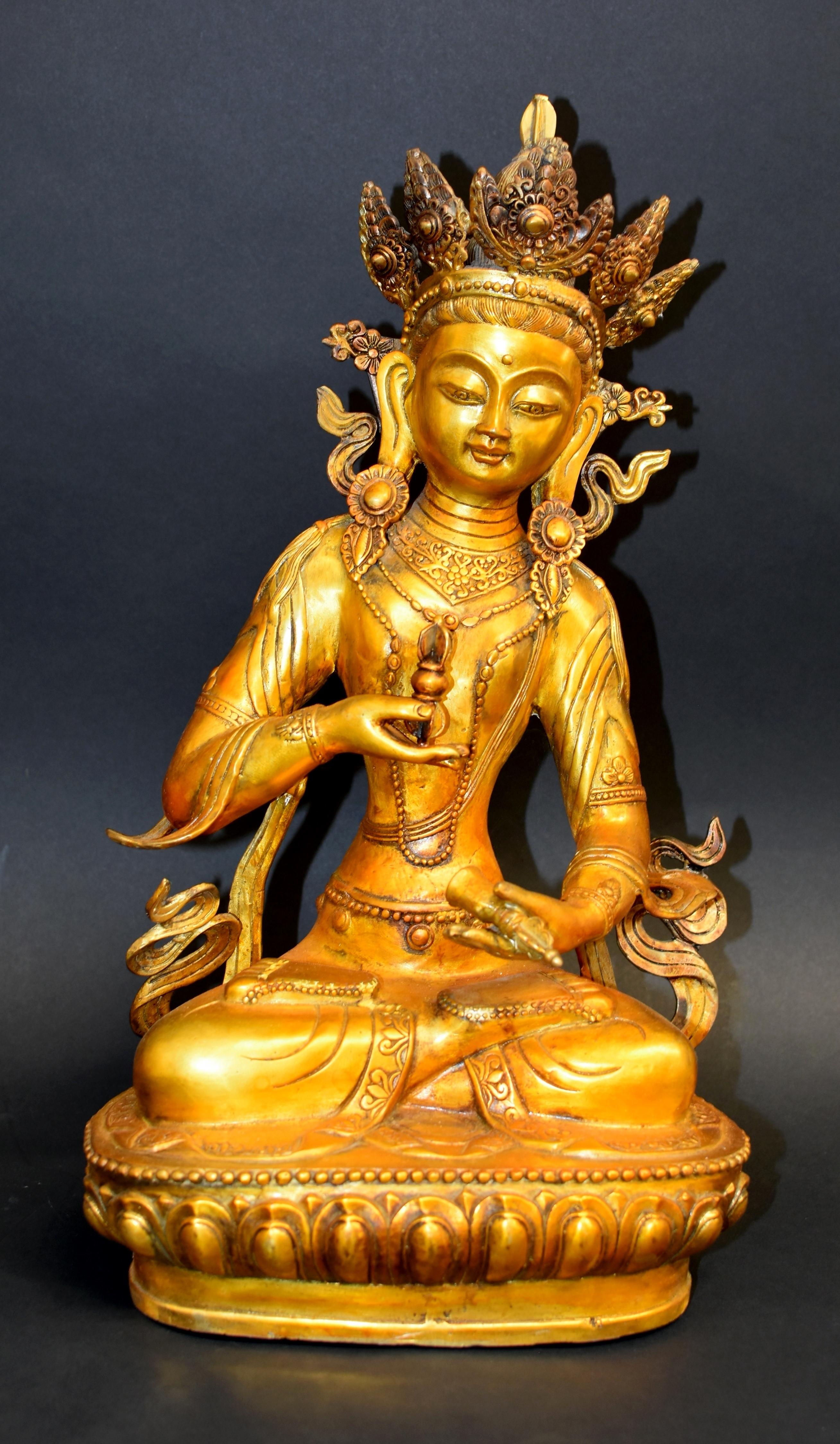 A large near 11 lb gilt bronze sculpture of Tibetan Vajrasattva. Seated padmasna on lotus throne, the Great Vajrasattva has large downcast eyes and pendulous earlobes, an urna on his forehead symbolizing the third eye to decipher and conquer evil,