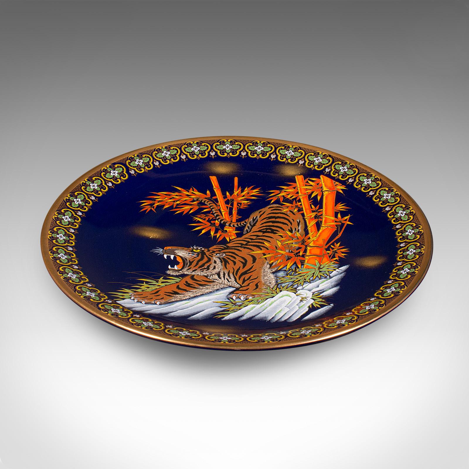
This is a large vintage tiger charger. A Chinese, lacquer ceramic display plate, dating to the late 20th century, circa 1980.

Striking tiger motif accentuates this generously sized plate
Displays a desirable aged patina and in good order
Appealing