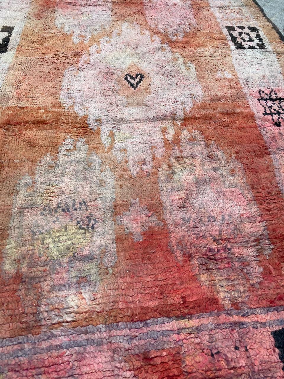 A Moroccan rug with beautiful tribal design and orange field, entirely hand knotted with wool velvet on wool foundation. Size: 5.70 x 9.84 feet.