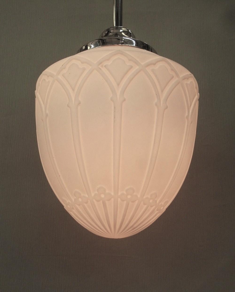 Large milk glass globe with rich detailing shown on a new nickel plated fitter.  The Tudor and/or Gothic inspired designs indicates it was most likely a vintage church fixture from the 1920s.  
The height of the design against the glass and the