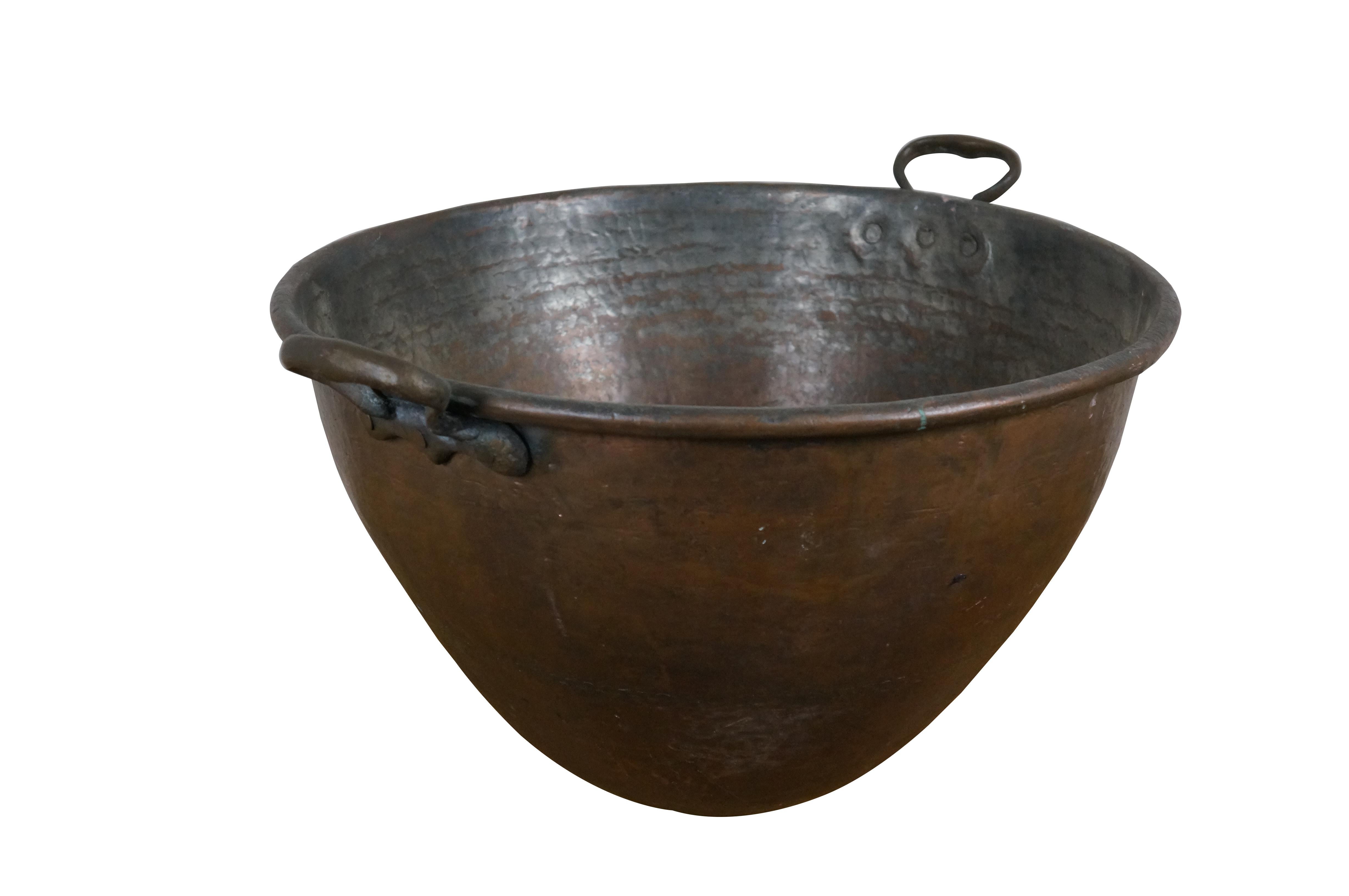 Grande calderone in rame martellato del XX secolo, con corpo affusolato a coda di rondine, bordo arrotolato e coppia di manici fissi in ottone. Prodotto in Turchia.

Dimensioni:
25