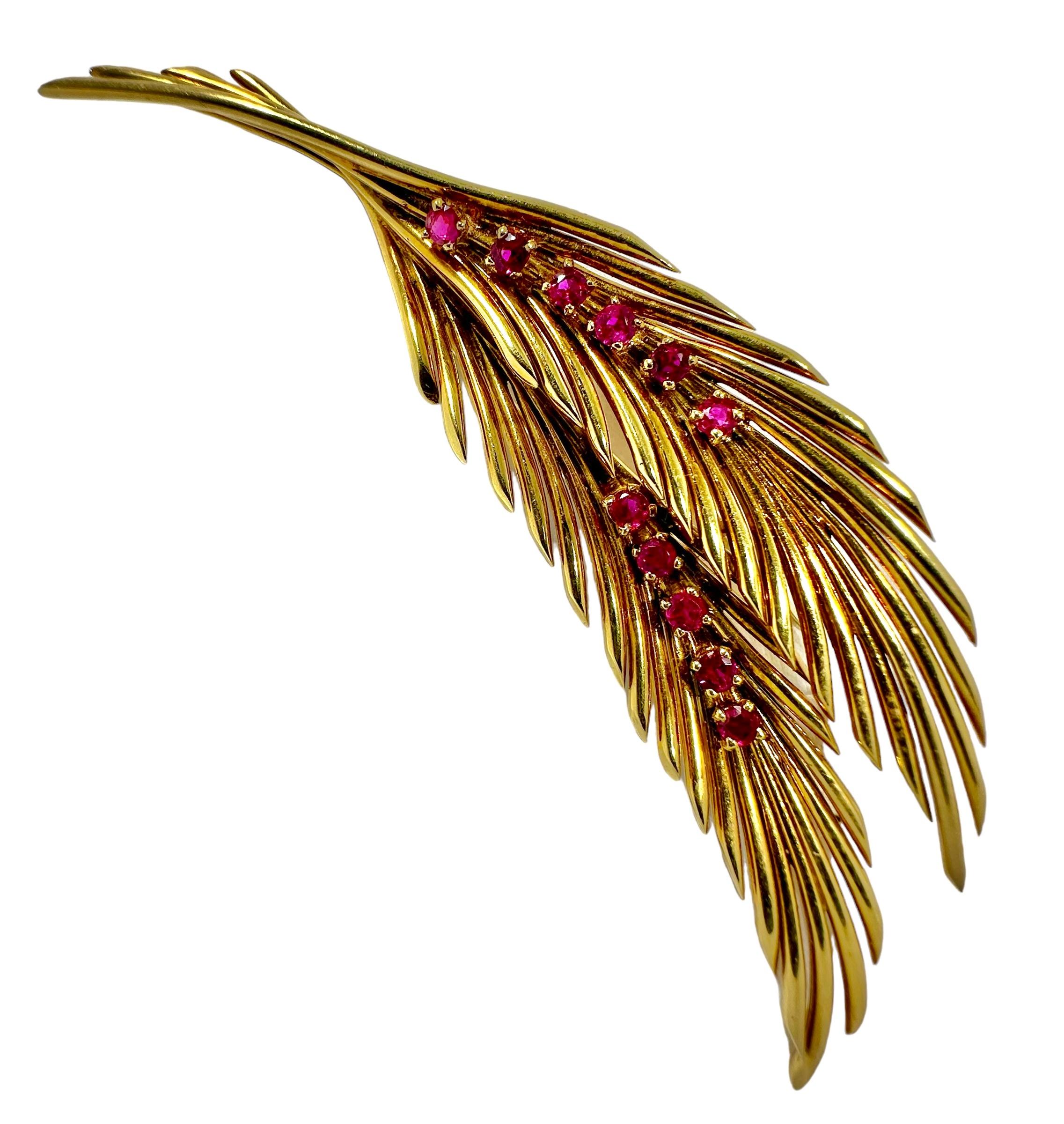This wonderful foliate brooch, crafted by esteemed maker Van Cleef & Arpels in 1958 is a classic design. Consists of one leaf gently resting on top of another leaf, set with 6 round faceted Burmese Rubies in a line down the center of the leaf on