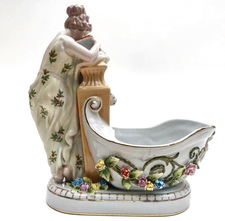 Fine Vintage porcelain sculpture - Girl reading a book. 

Hand-painted. 

Stamped and numbered. 

Germany 

There are some traces of time in the form of a small shallow crack and chipped several petals. 

 Size:

Height 9.8 inc (25