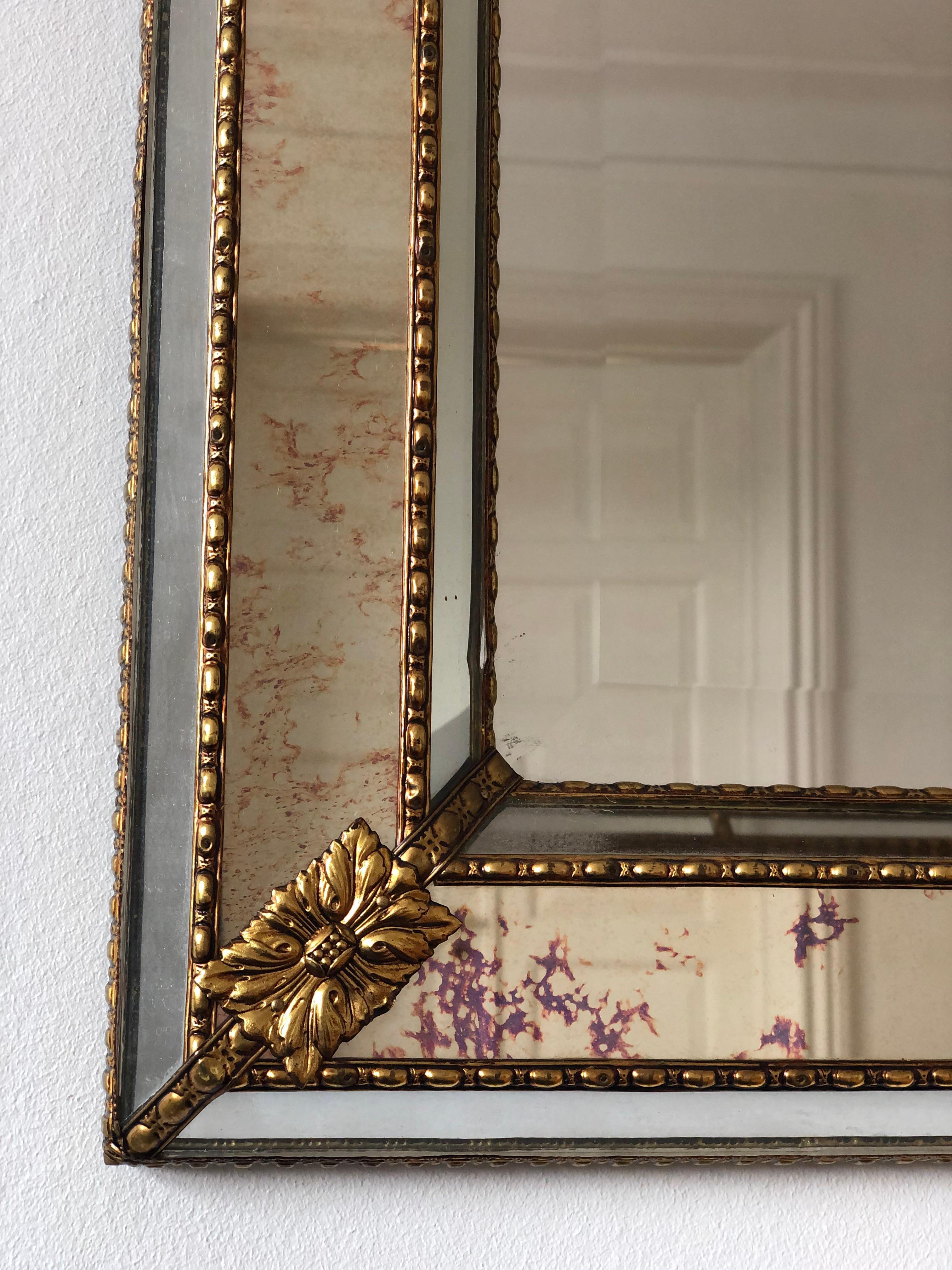 Vintage Venetian large beveled mirror in Spanish style, dating back to the 1990s.
The smoked glass frame is beautifully hand-crafted and decorated with small crystals on the outer and inner edges, with larger crystals running along the center. The