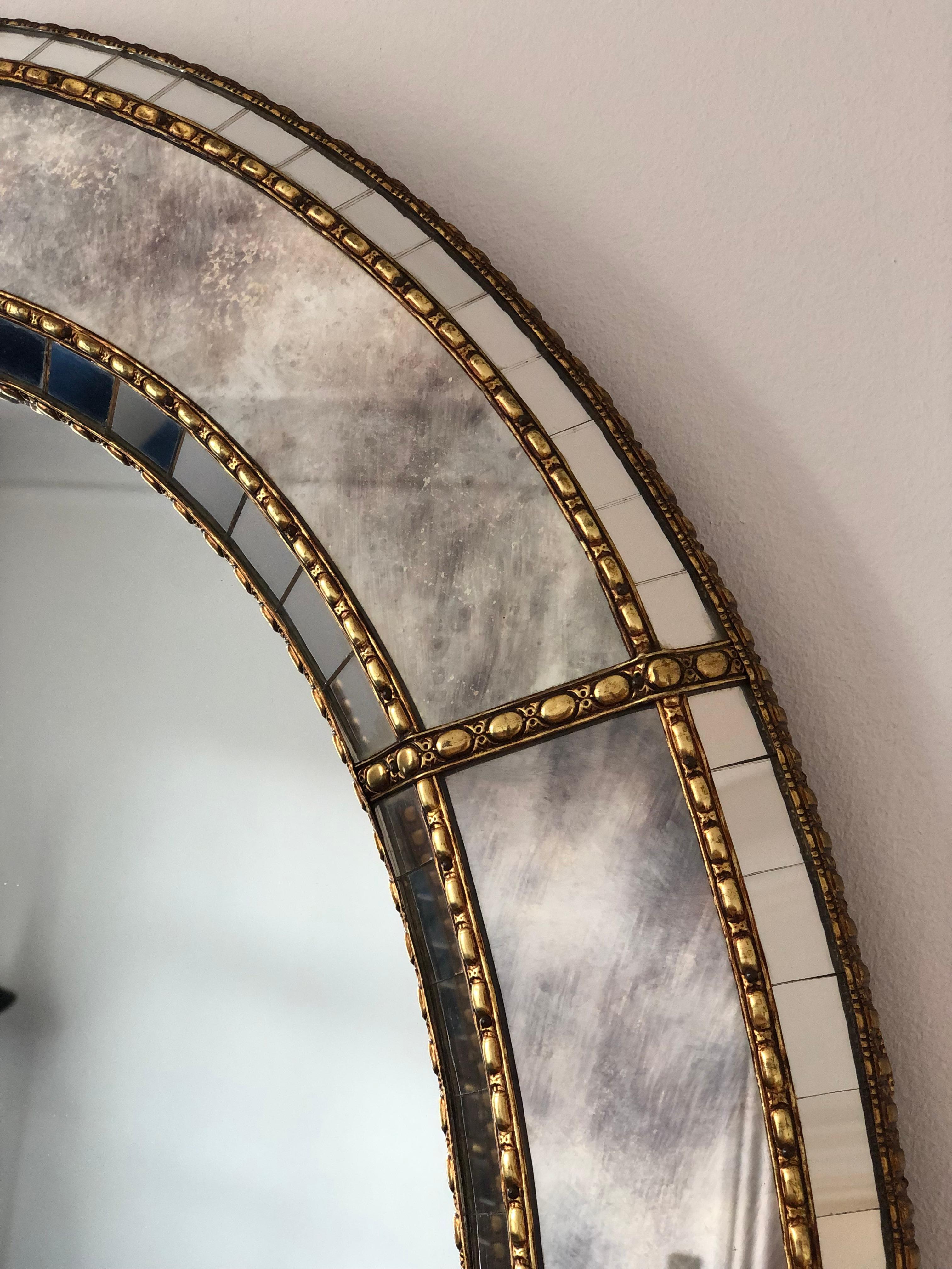 Vintage Venetian large beveled mirror in Spanish style, dating back to the 1990s.
The smoked glass frame is beautifully hand-crafted and decorated with small crystals on the outer and inner edges, with larger crystals running along the center. The