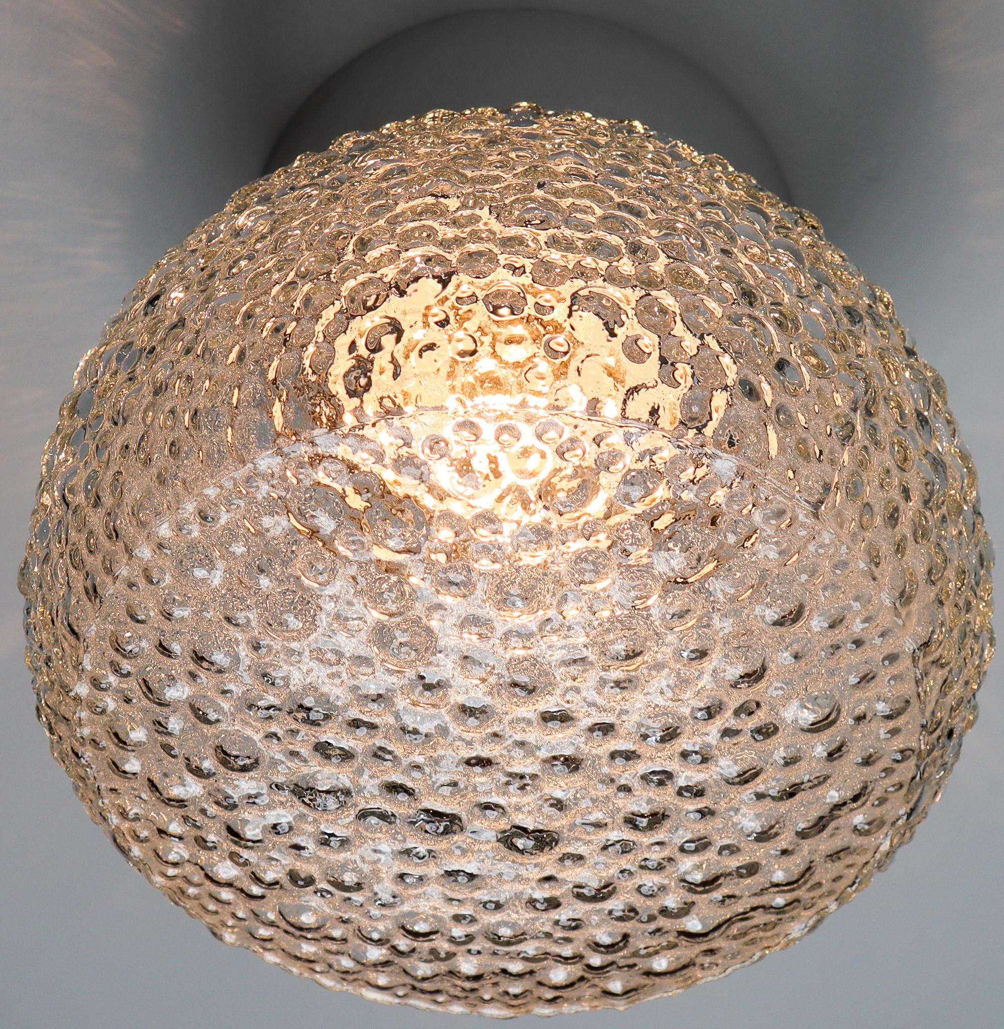 Large vintage modern wall/ceiling lights with clear bubble glass and porcelain base, France, 1960s. The glass has pattern in it, what gives a nice diffuse light effect and a nice pattern on ceiling and walls, these wall scones/ceiling lights will