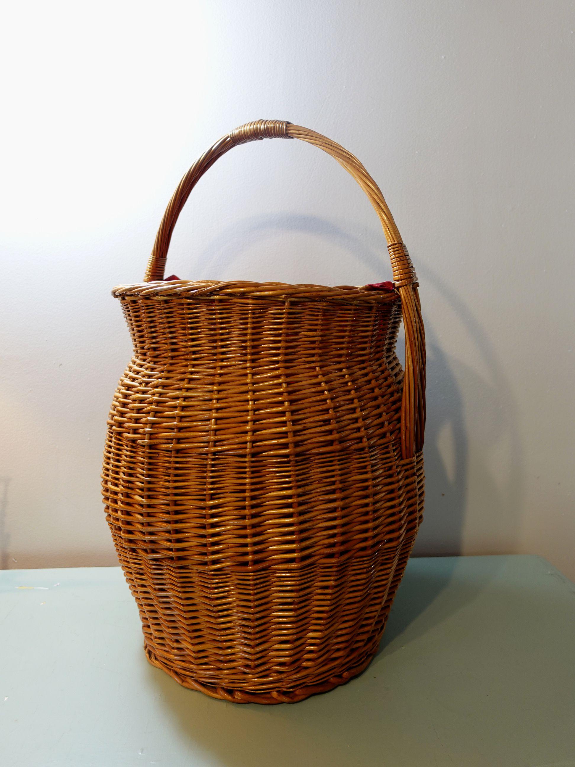 This is a very large and lovely vintage and fabric-lined basket with a half-moon handle. It's big enough to be a hamper. It appears to be quite solidly made, with no structural issues whatever. Even the fabric looks clean, but it's vintage. Good