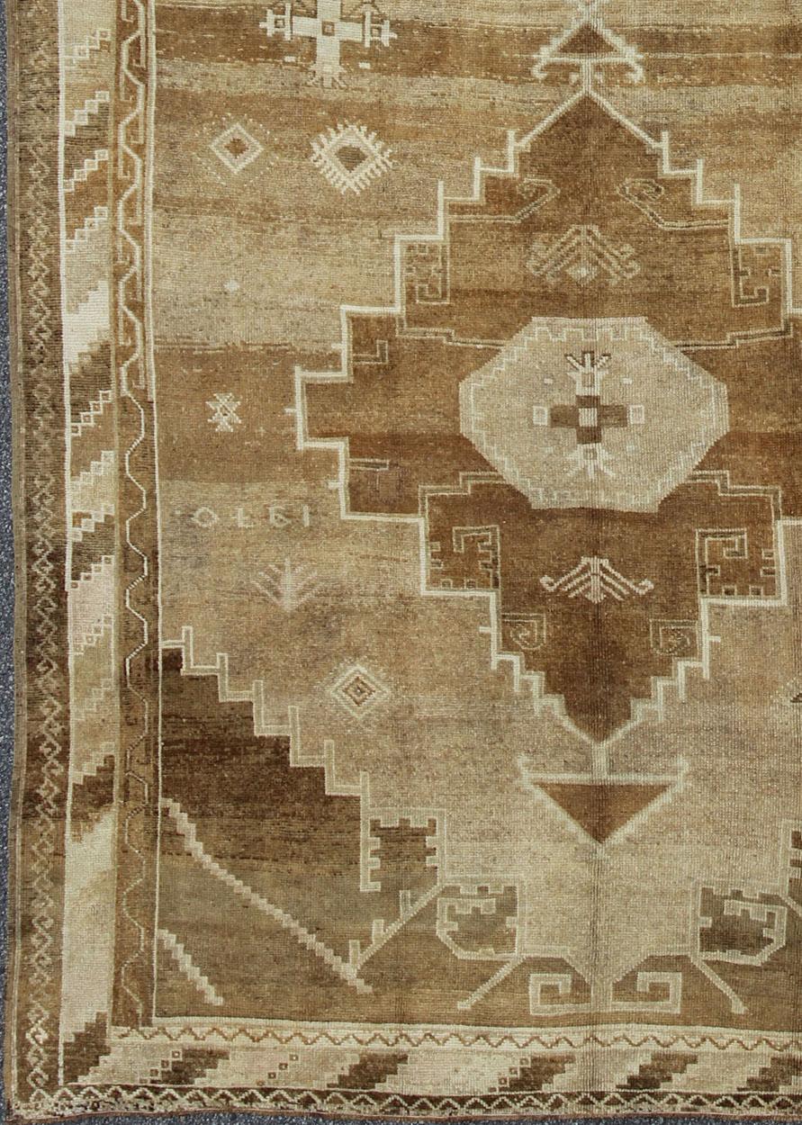 Vintage wide gallery runner/rug from Eastern Turkey with two medallion design, rug EN-92101, country of origin / type: Turkey / Oushak, circa 1940.

This vintage Turkish Oushak rug features a dual medallion design flanked by geometric motifs in