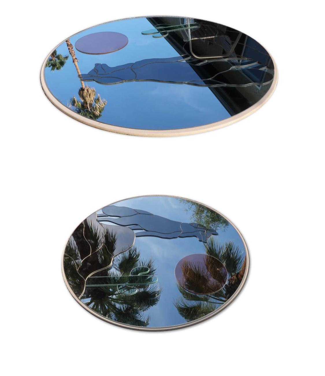 It is hard to describe just how stunning this mirror is. Mounted on a white painted wood board, this is three and a half feet wide with colored pieces of mirror applied to a large round mirror to create an image of a coyote or wolf standing on a
