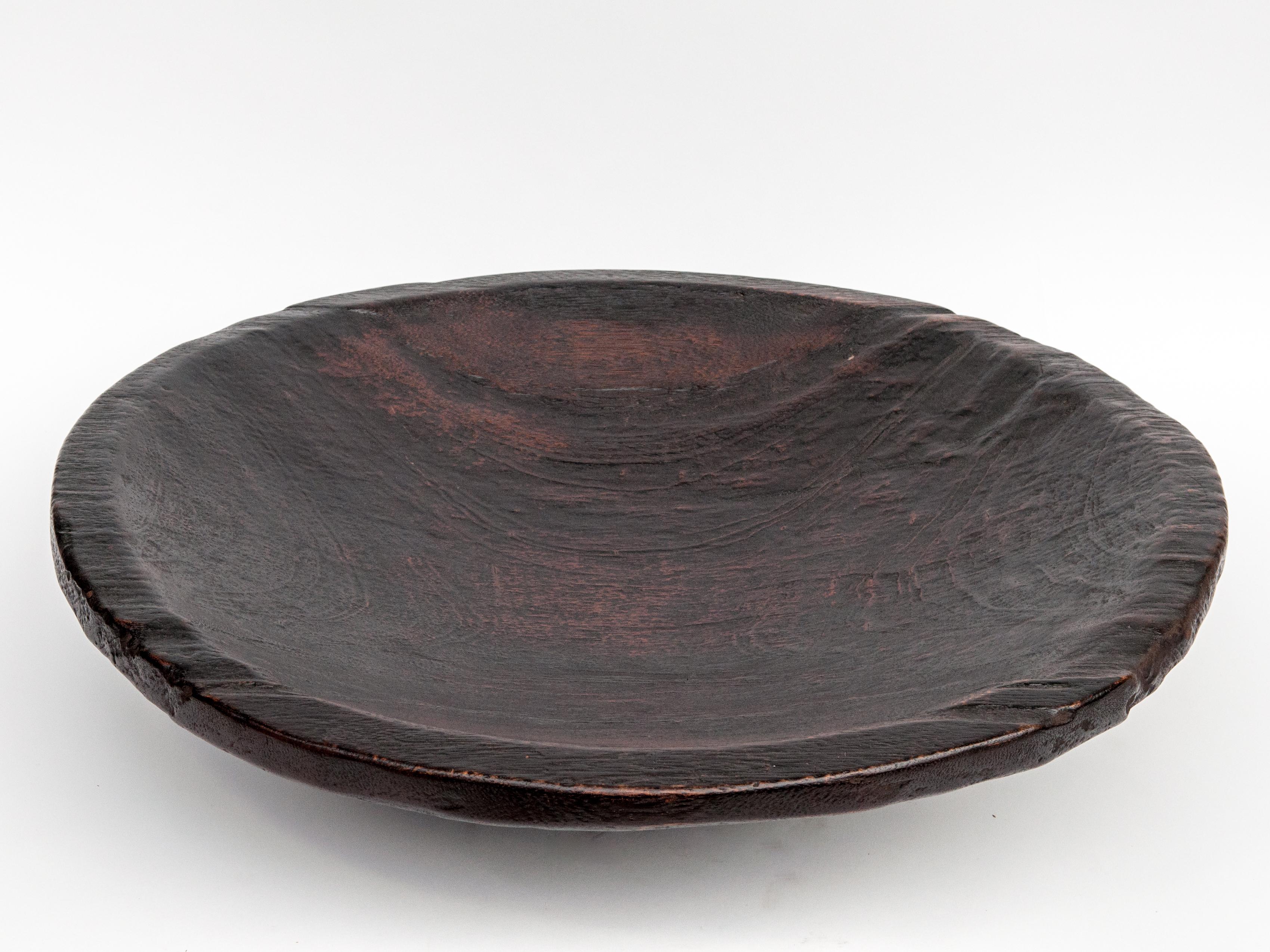 Large vintage wood bowl, Sumatra, jackfruit wood, stained, mid-late 20th century
This bowl was fashioned by hand from a single piece of jackfruit wood, and was used to as an impressive presentation piece to serve food and fruit in feasts and