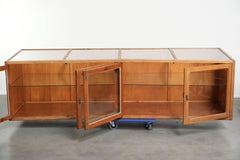 Large vintage wooden counter / display cabinet with 4 doors and glass