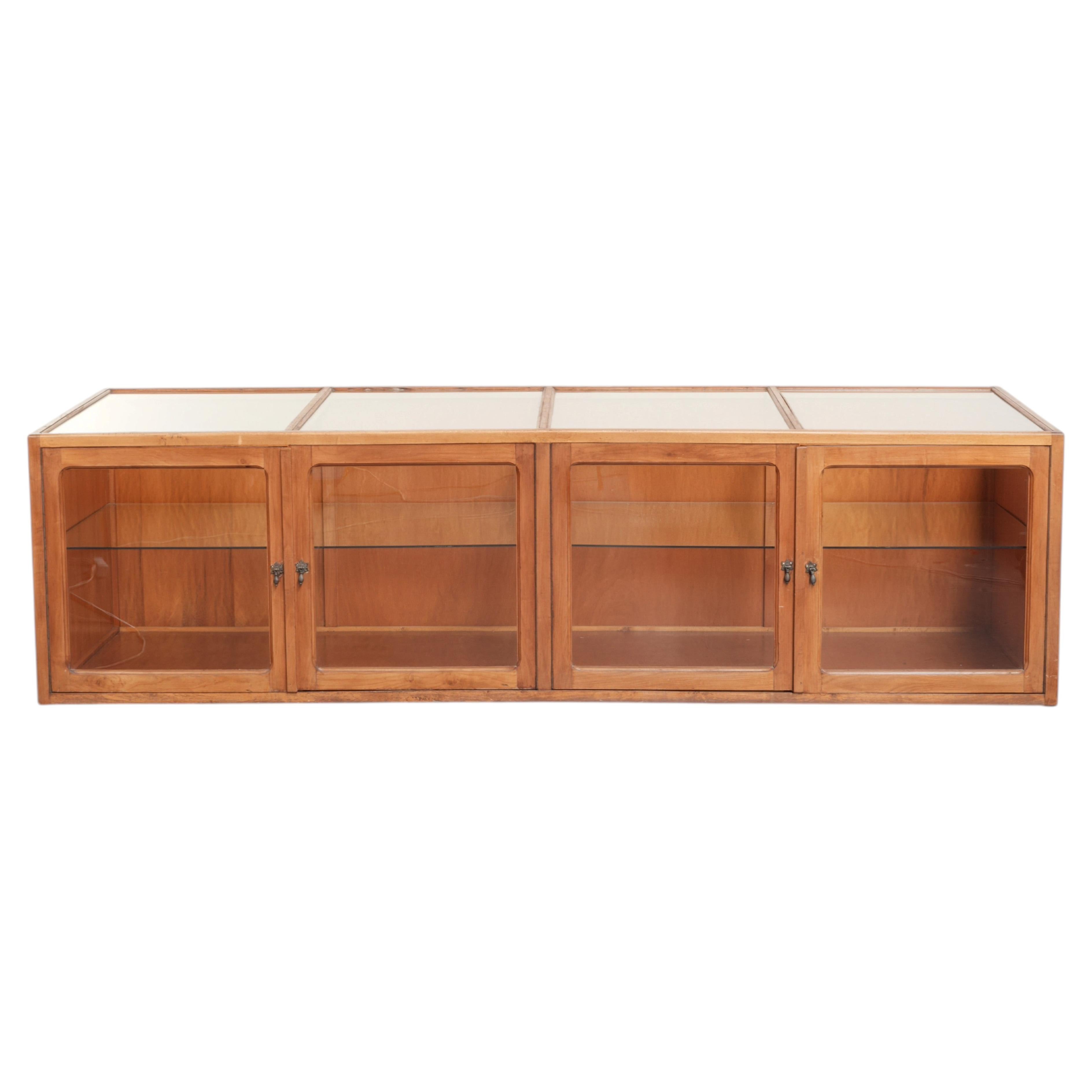 Large vintage wooden counter / display cabinet with 4 doors and glass
