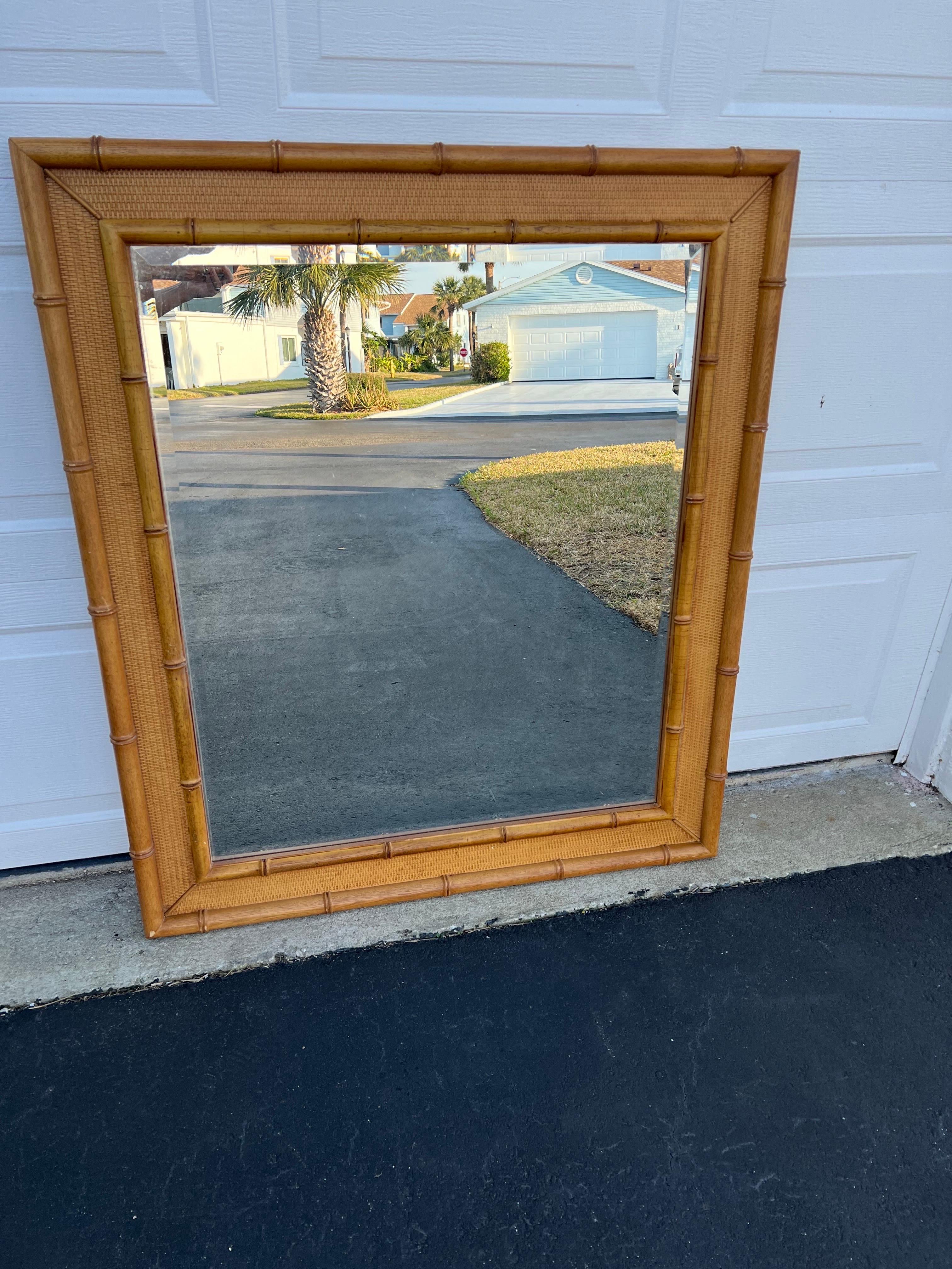 Large Vintage Wooden Faux Bamboo Mirror. Nice thick mirror in the style of Tommy Bahama. Nice wood and textured woven wicker interior and a nice one inch bevel.