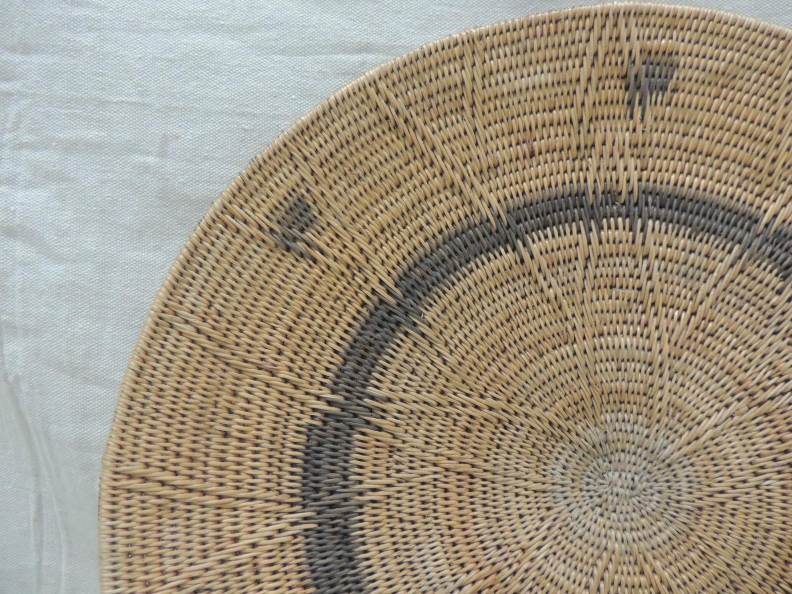Large vintage woven seagrass ethnic round African deep basket.
Artisanal handwoven basket with tribal designs and patterns all around.
(Is not flat is more like a deep bowl shape, double woven technique.)
Size: 18.25” D x 2” H.



