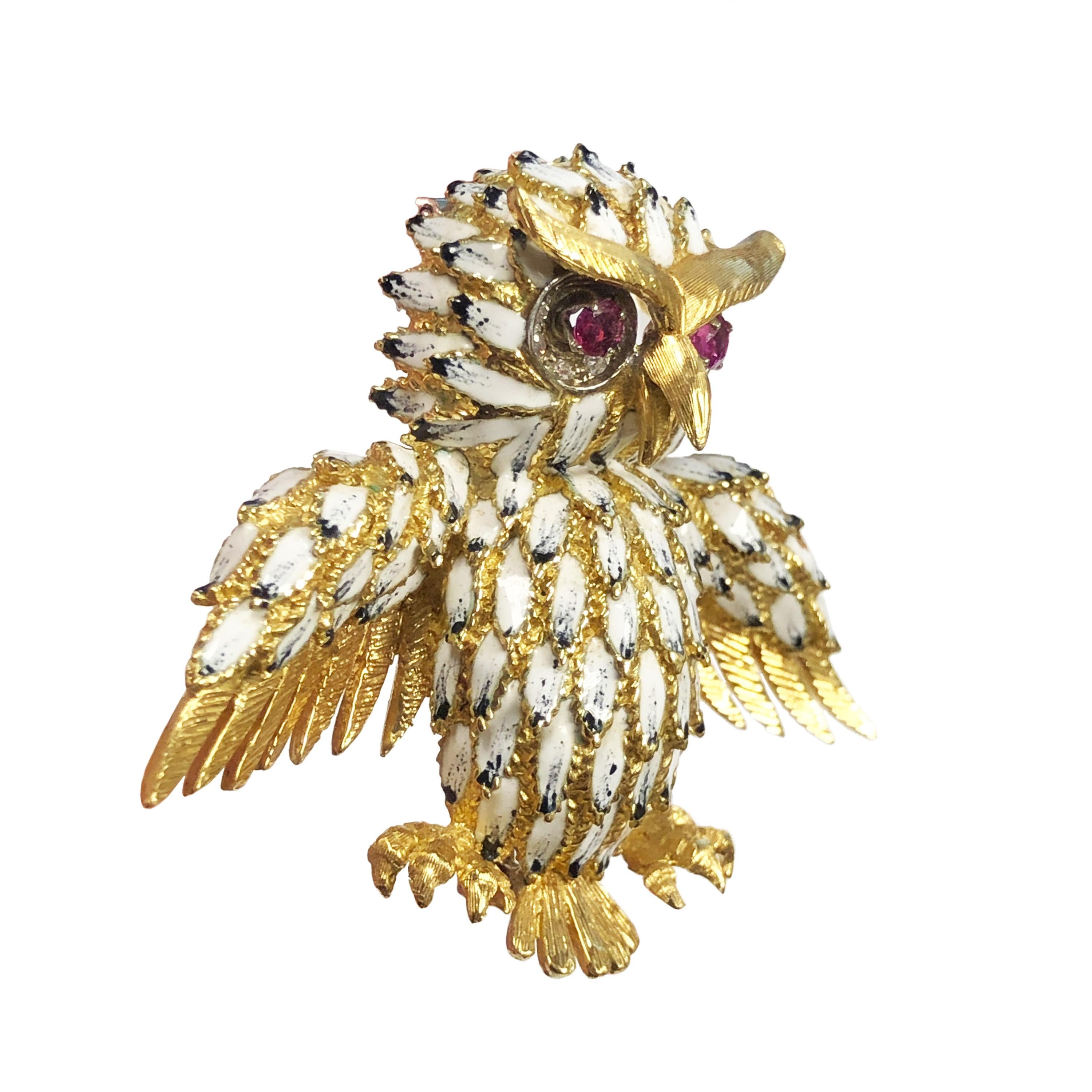Circa 1970s 18K Yellow Gold Owl Brooch, measuring 2 1/2 inches from wing end to end, 2 inches tall and weighing 33.2 grams. Finely detailed with Hand Chased Gold work, Enamel Feathers and Ruby and Diamond set Eyes. Having a Double pin Clip fastener. 