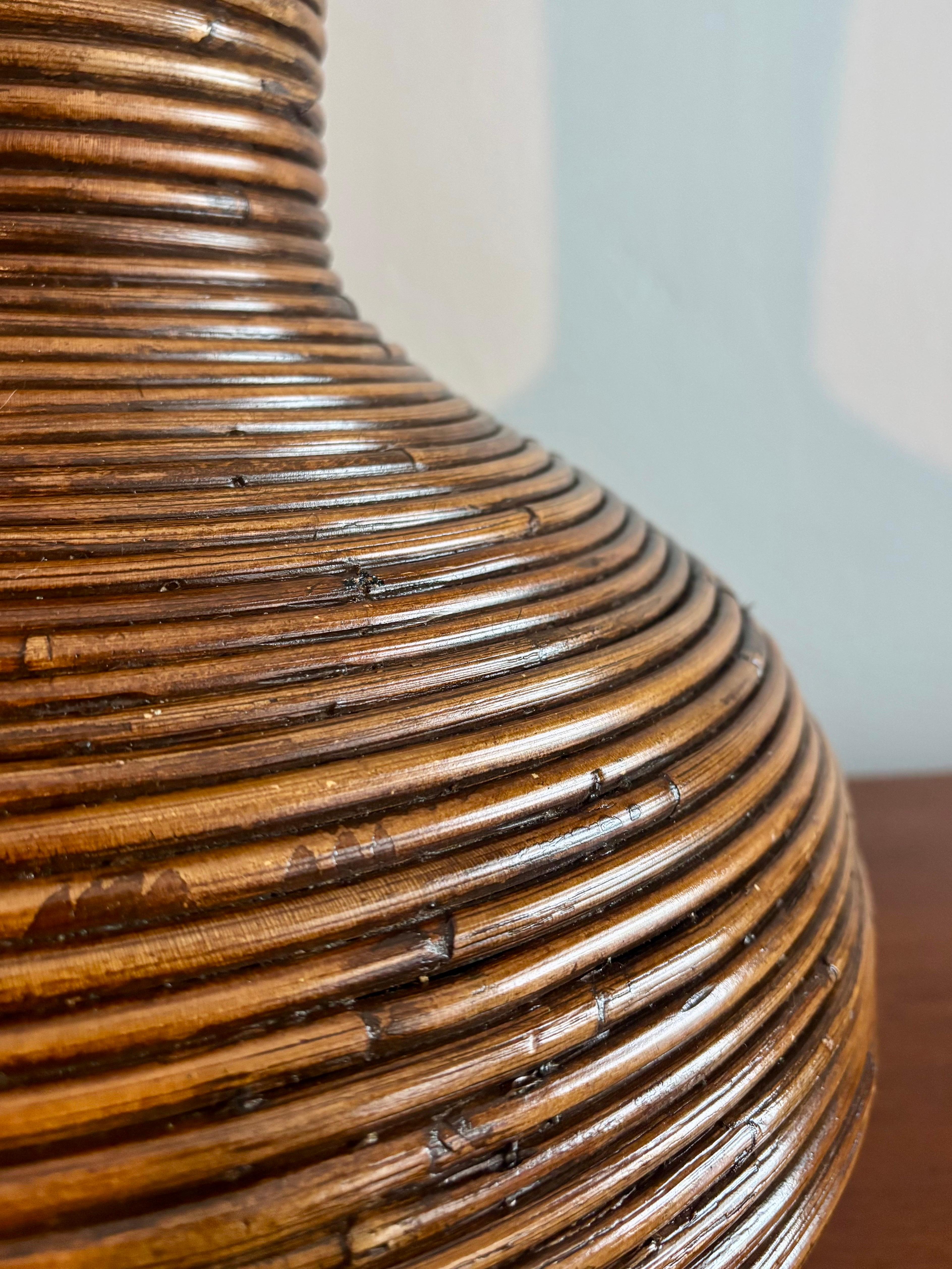 Beautiful large vase constructed completely from spiraled rattan vine. Expertly hand crafted and held together with tiny nails. A great piece that could be used for dried arrangements or simply on its own accord. Great as a floor vase or