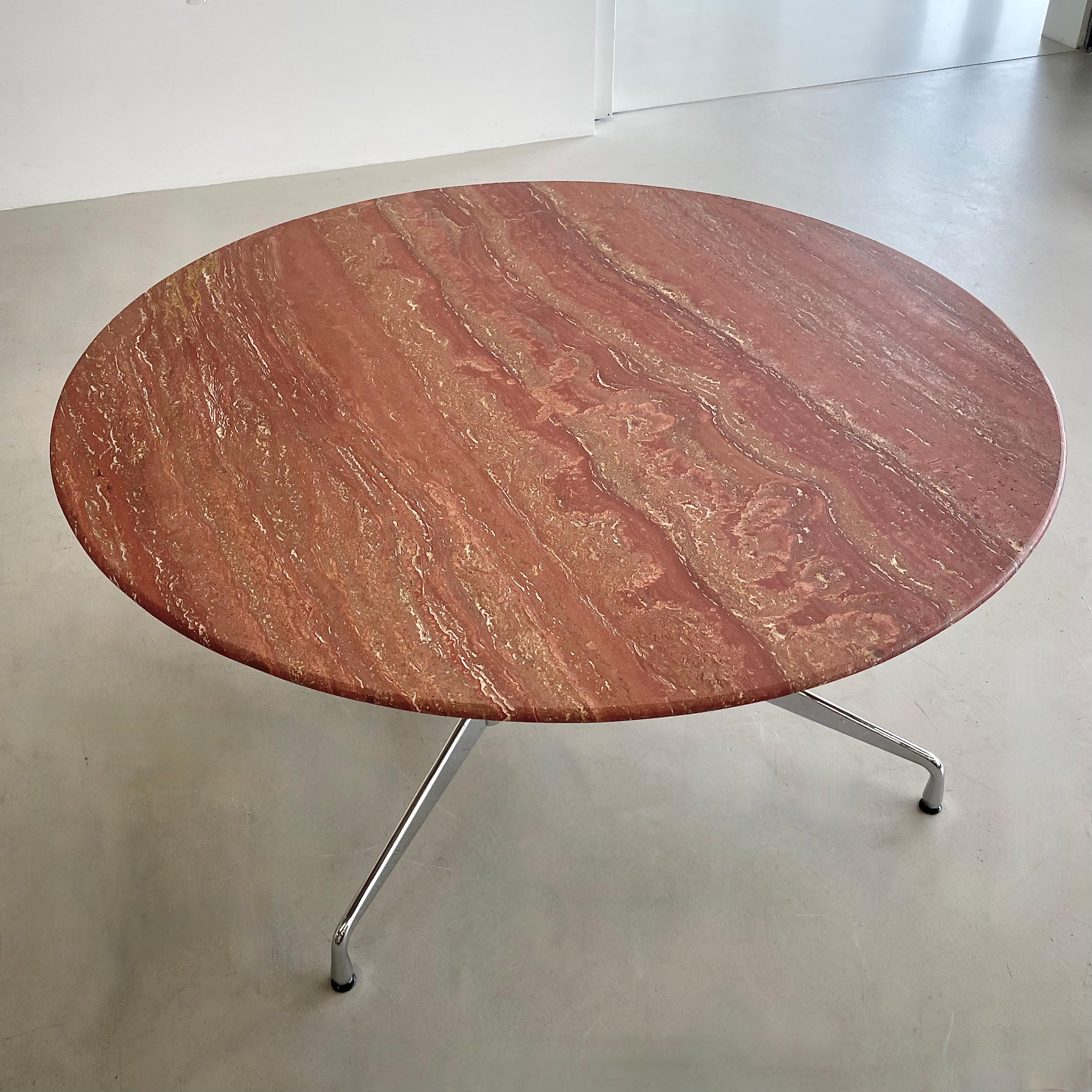 Full chrome-plated 'Segmented Table' base by Ray and Charles Eames (64100 series) with a round stone top made of matt 'Rosso Persiano' Travertine. The base retains the original Vitra label, dated 2008.

Released to the market in 1964, the Eames