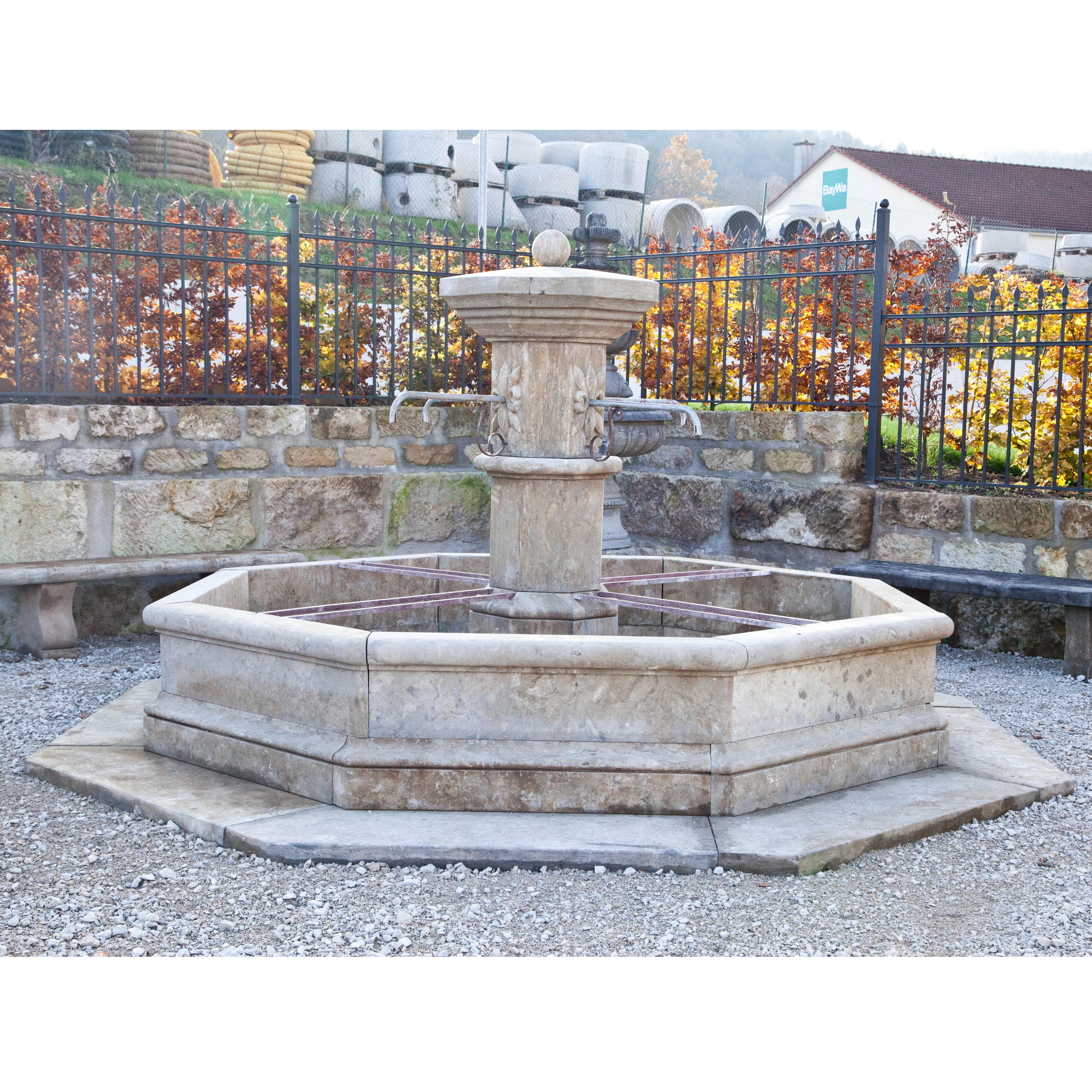 Large blue stone wall fountain with rectangular basin. The back wall is architecturally structured and equipped with two spouts. Basin height 50 cm. (measurement fountain basin: 63 x 300 x 300 cm).