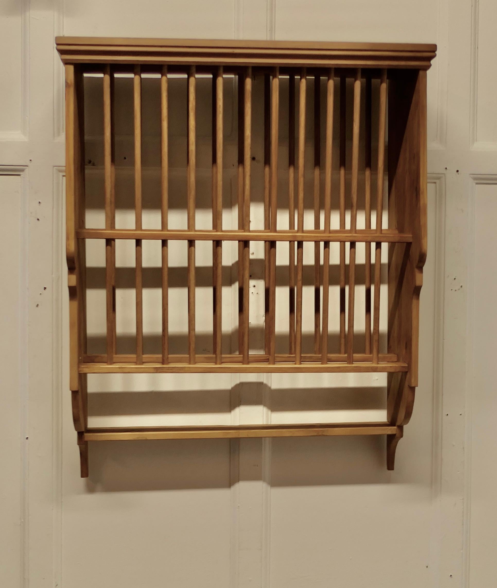 Large Wall Hanging Pine Plate Rack

This useful piece hangs on the wall and drains and stores plates until required
It has a pine frame and wooden dowels with a waterfall shape, allowing 2 rows of plates to be stored at any one time, below there is