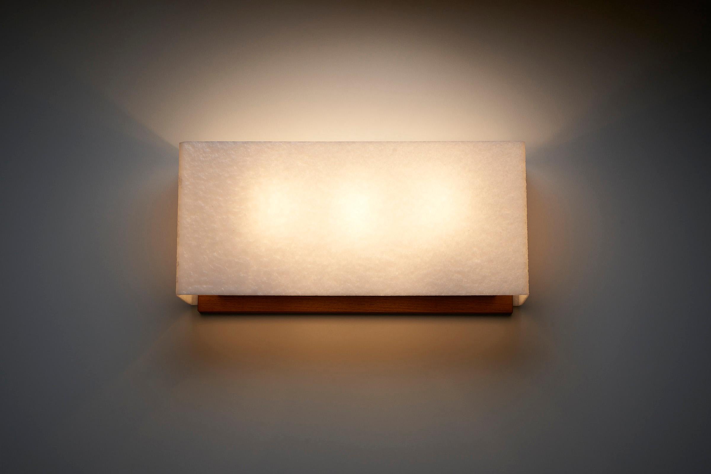 Introducing the Large Wall Lamp with Textured Diffuser and Teak Frame, a remarkable piece crafted by Kontakt-Werkstätten in Germany. This wall lamp stands out with its generous width, measuring 45cm, which adds a captivating focal point to any room