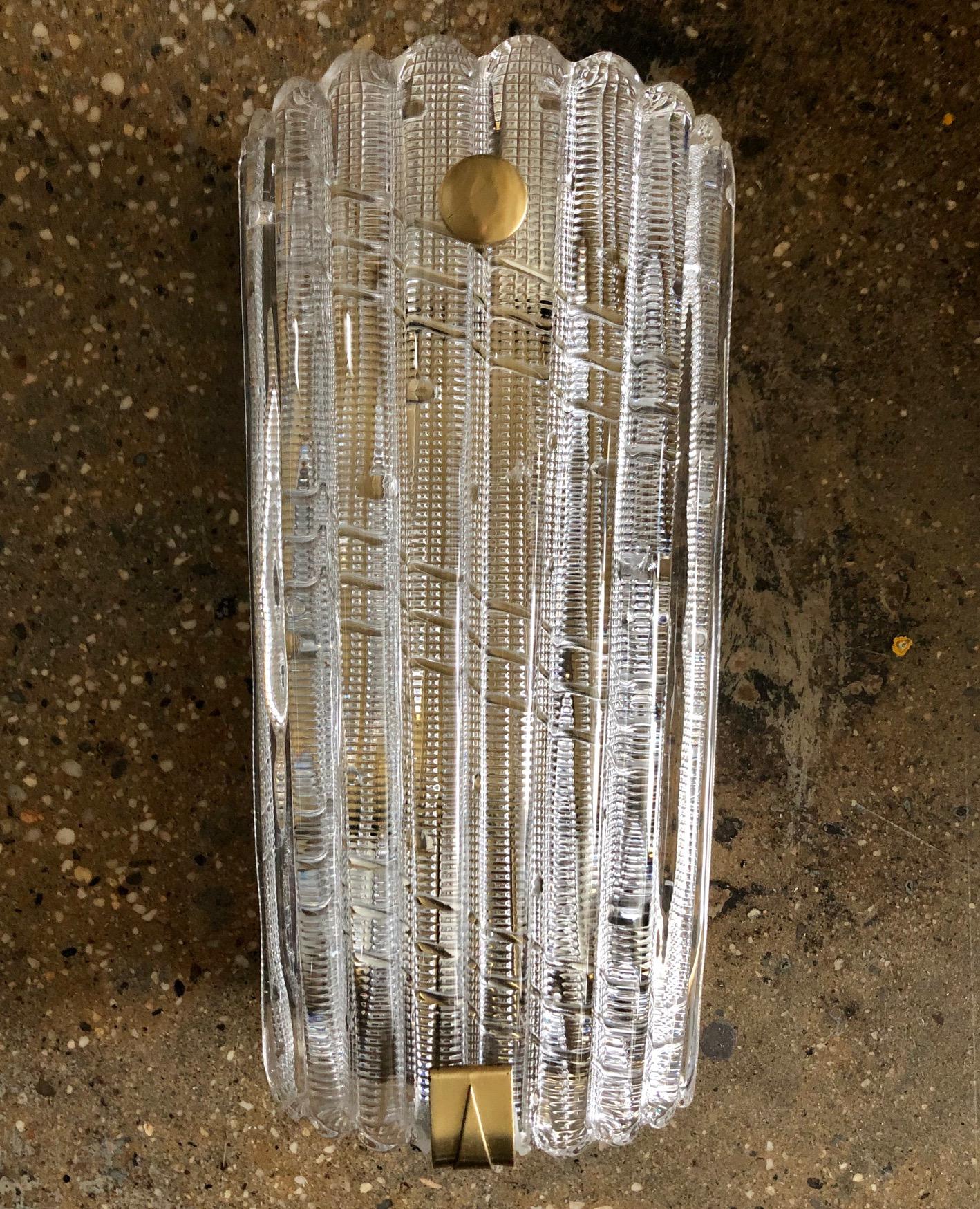 Large vintage wall light designed by Carl Fagerlund for Orrefors, Sweden, circa 1950. Crystal glass with brass hardware. (3) Edison style bulbs.