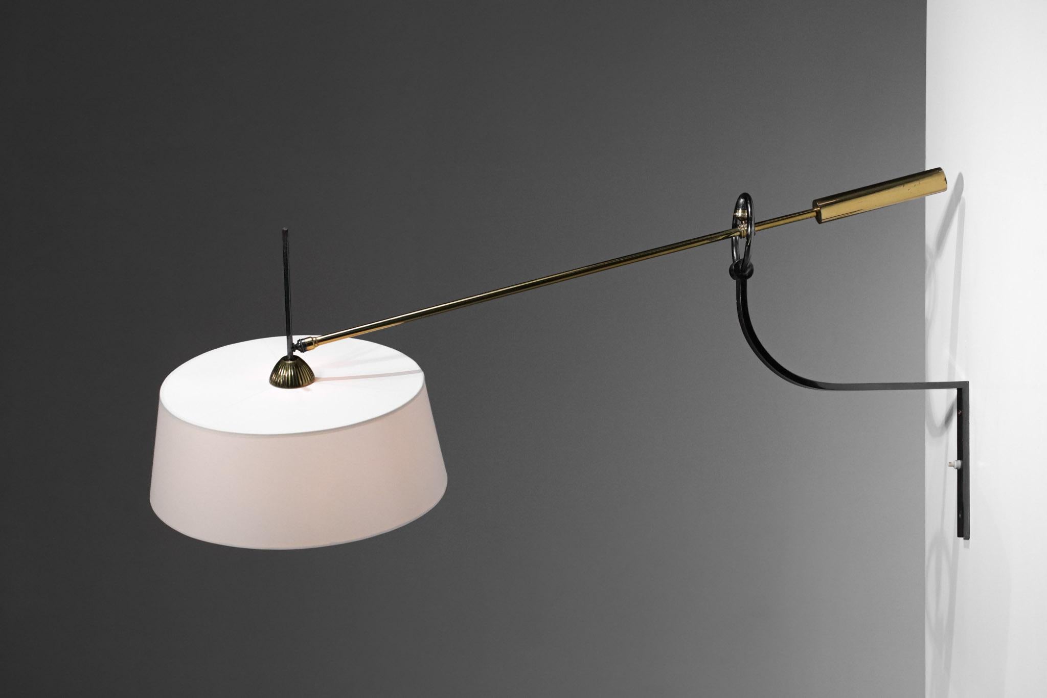 Large wall lamp from the 60's edited by the Maison Arlus. Arm and counterweight in solid brass, black lacquered metal clamp and fabric shade made to measure. Possibility to orientate the stem and the shade thanks to a ball joint located in the