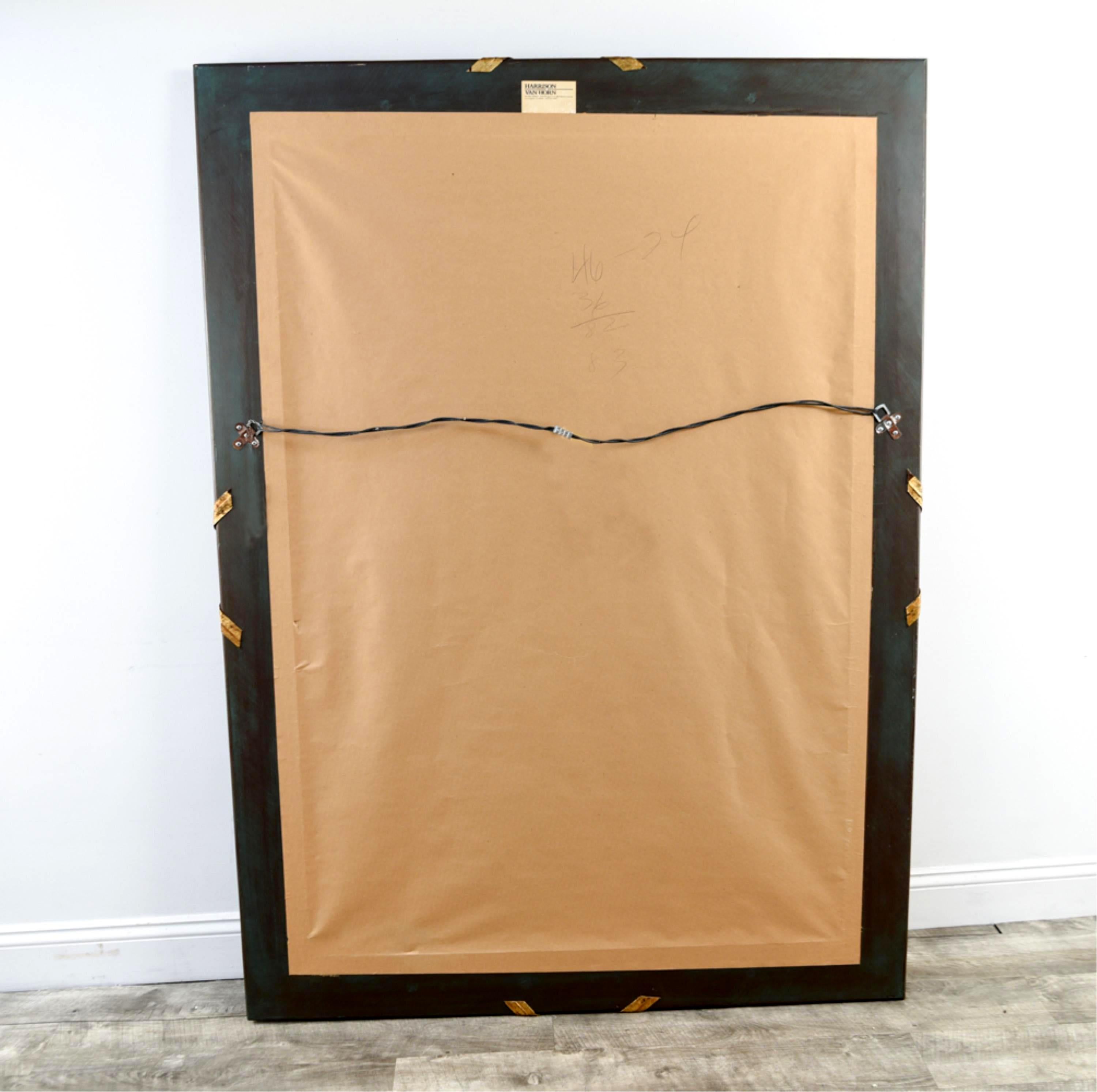 A large wall mirror by Harrison Von Horn in neoclassic style with a modern twist, circa 1980s. It is of a very heavy construction and impresses the viewer with a detailed fluted hardwood frame that resembles reeds . It was finished in a subtly